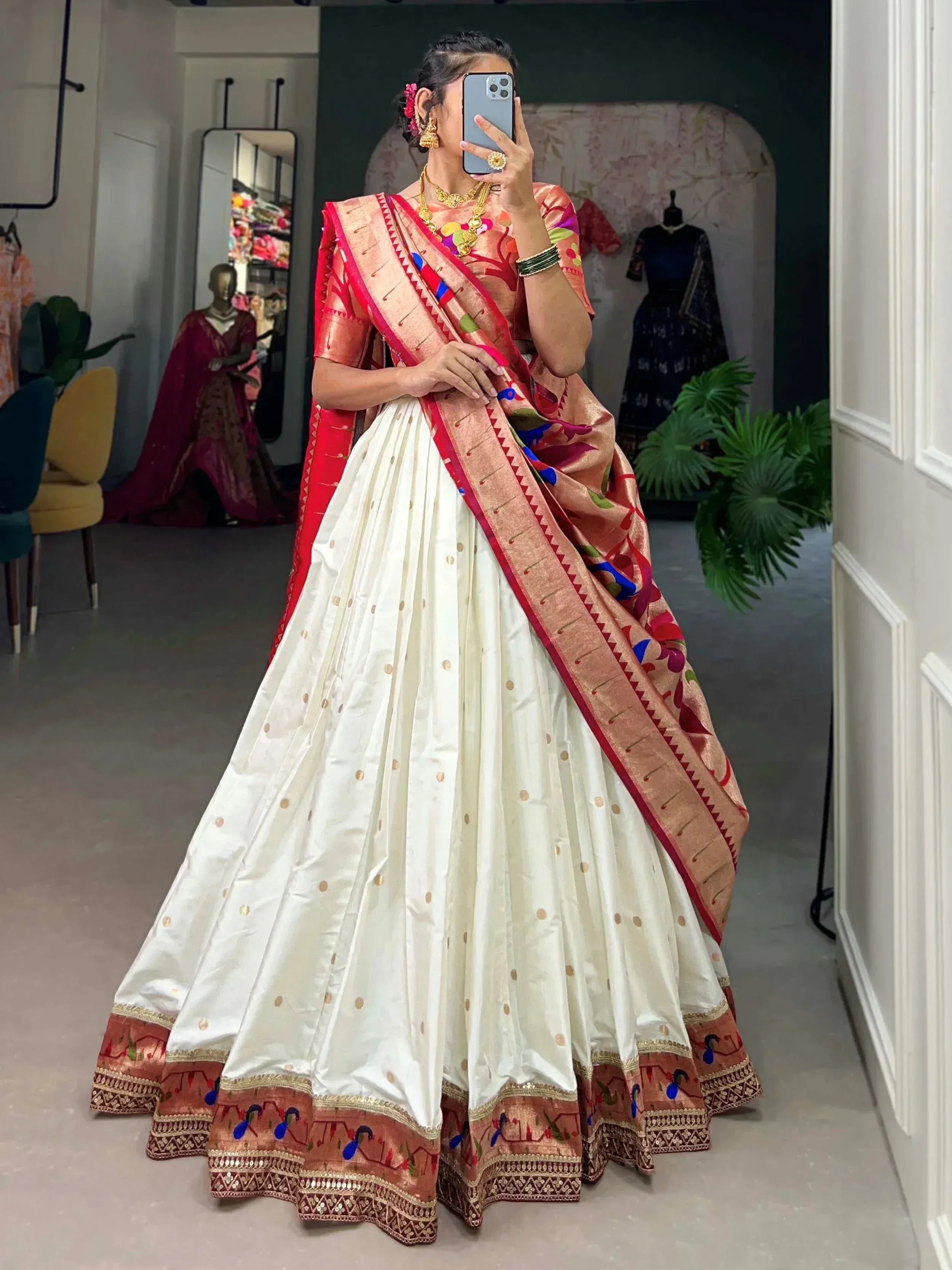 Woman in white and red ethnic saree with gold embroidery, traditional Indian wear