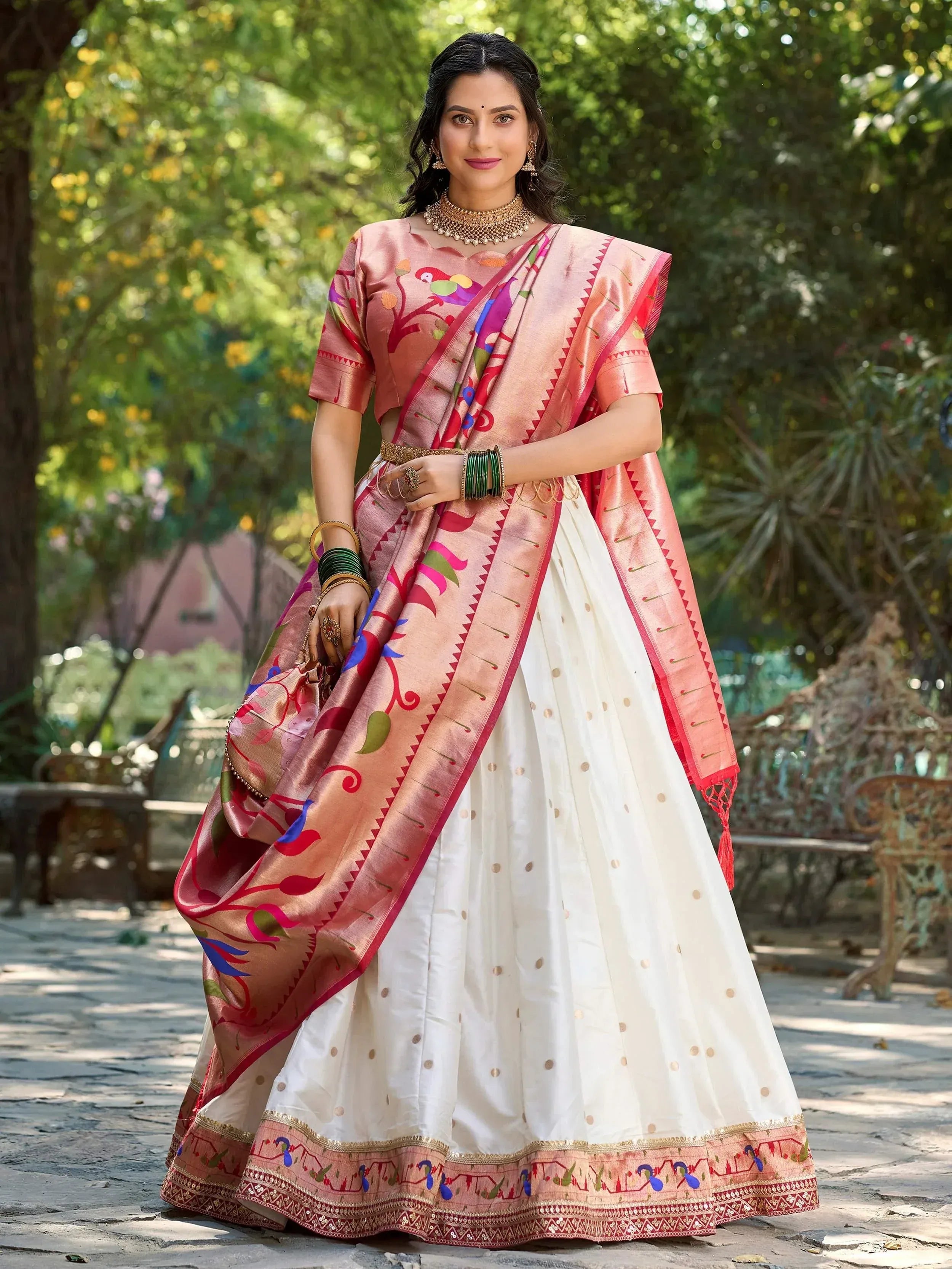 Woman in pink floral printed saree with white polka dot lehenga, traditional Indian ethnic wear