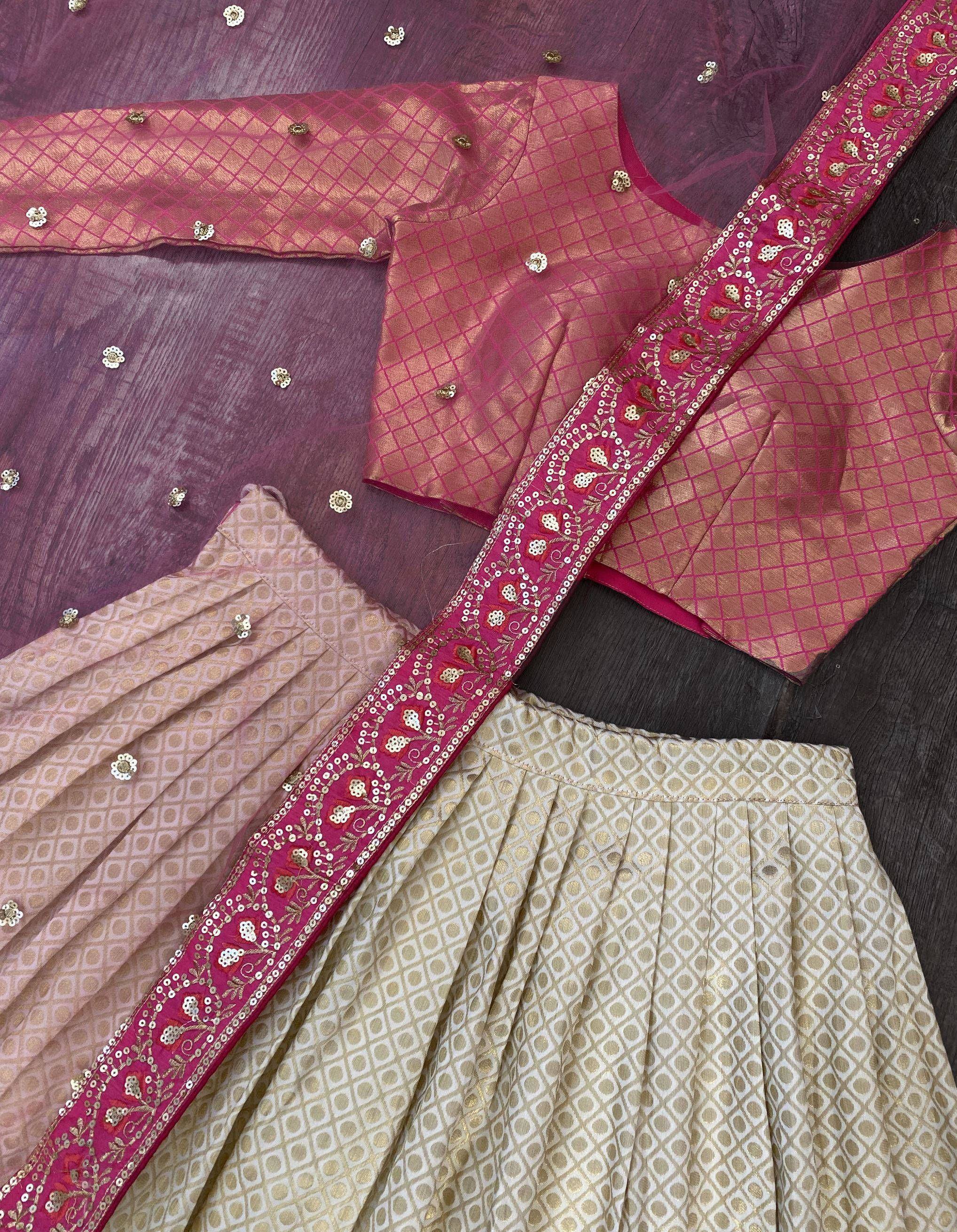 Elegant pink and gold ethnic lehenga choli with intricate embroidery and sequin detailing
