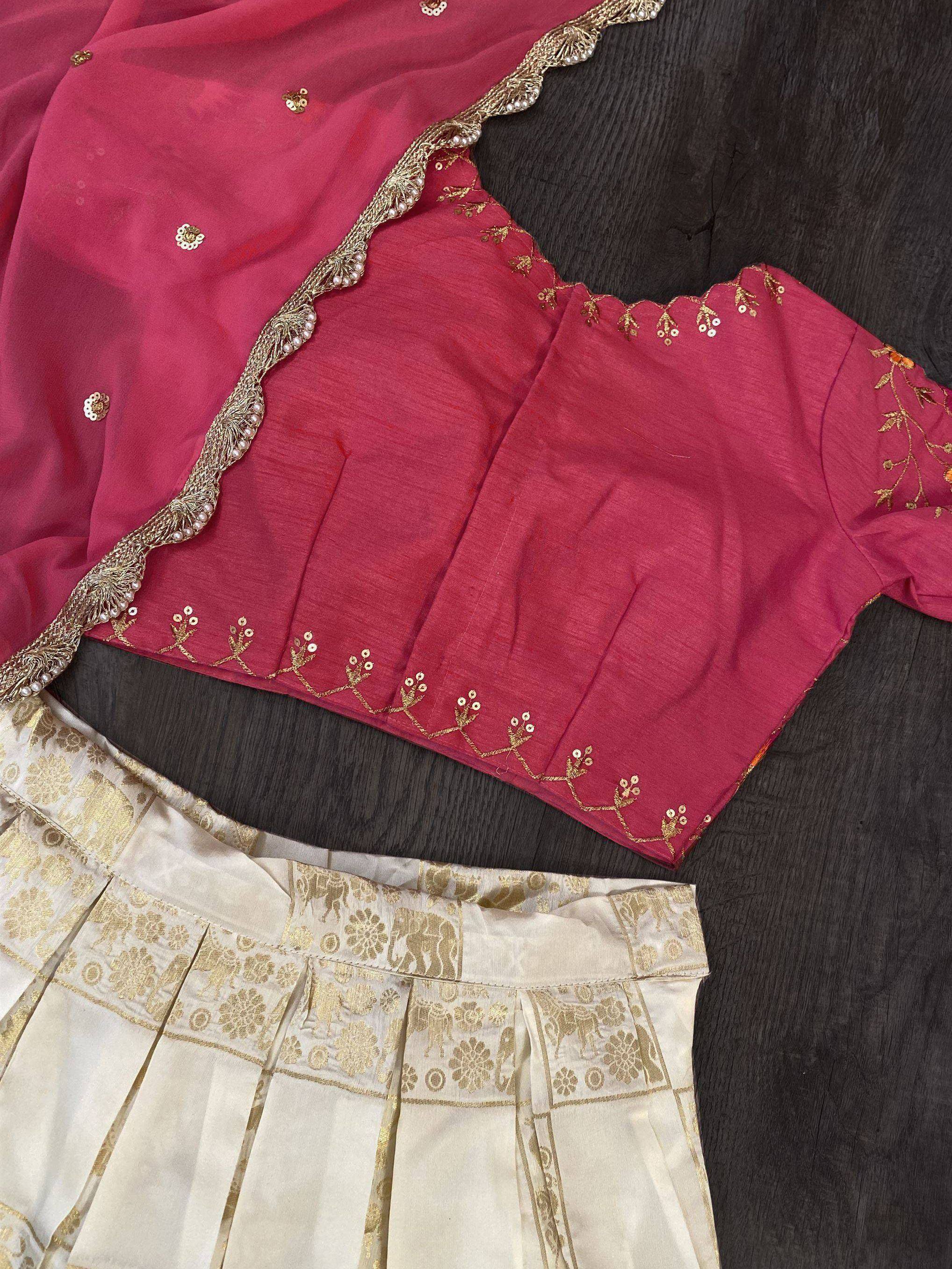 Pink embroidered blouse with gold detailing, paired with cream pleated skirt and dupatta, showcasing Indian ethnic wear.