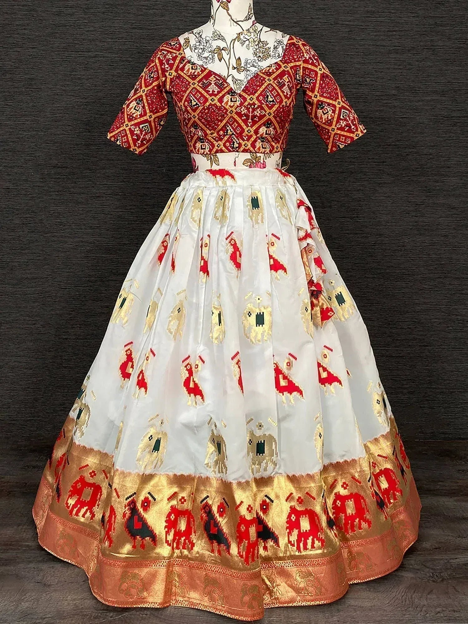 Red and white printed lehenga choli with elephant motifs and gold border, ethnic Indian wear