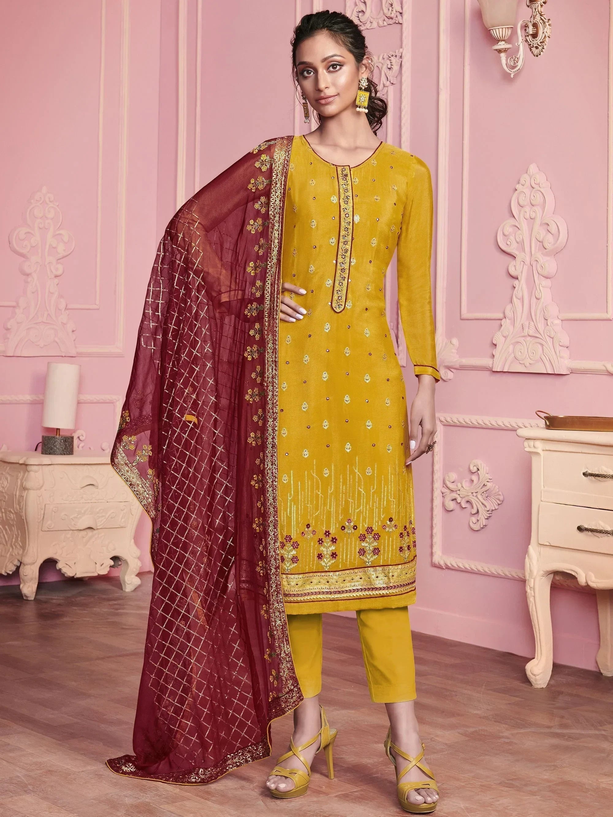 Woman in yellow embroidered salwar kameez with maroon dupatta, traditional Indian ethnic wear