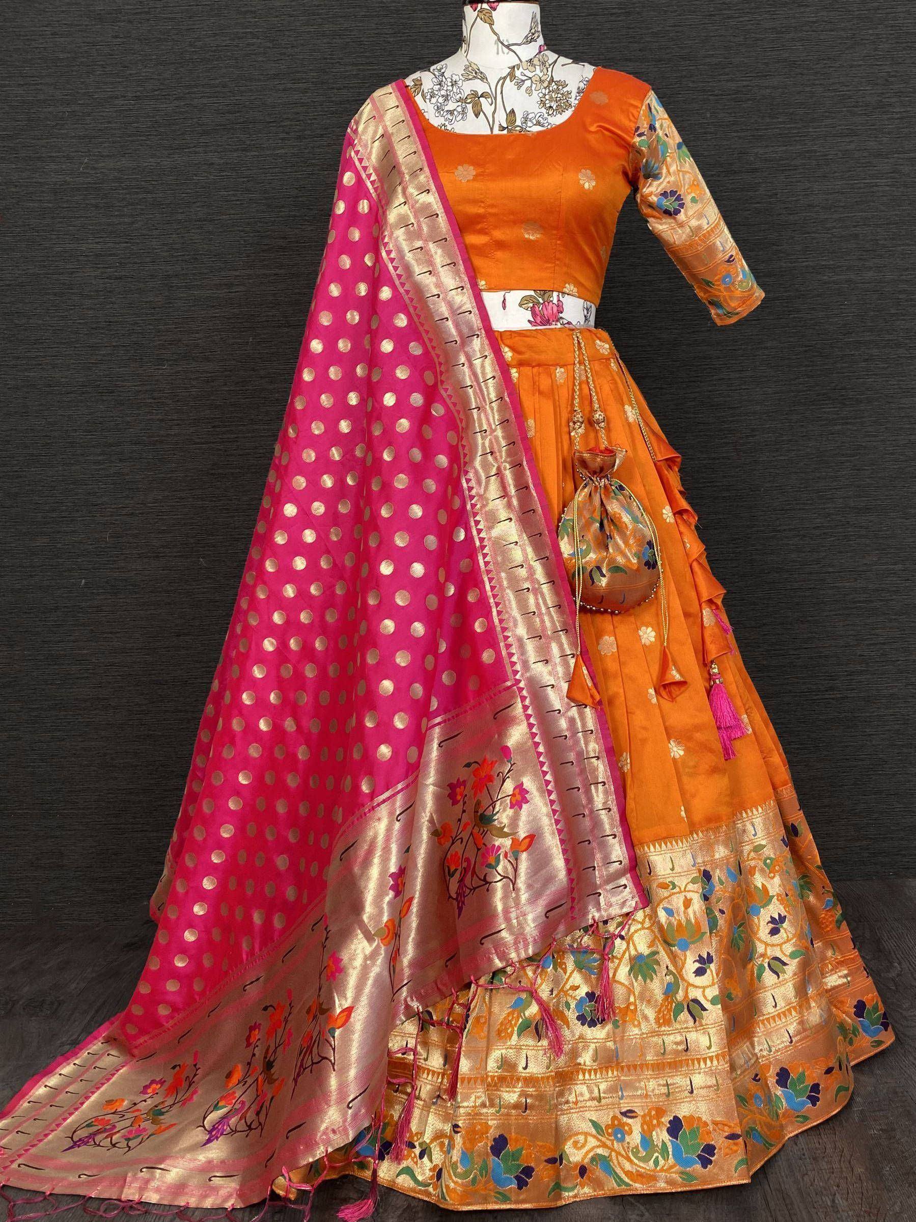 Orange floral lehenga choli with pink polka dot dupatta, ethnic Indian wear for festive occasions