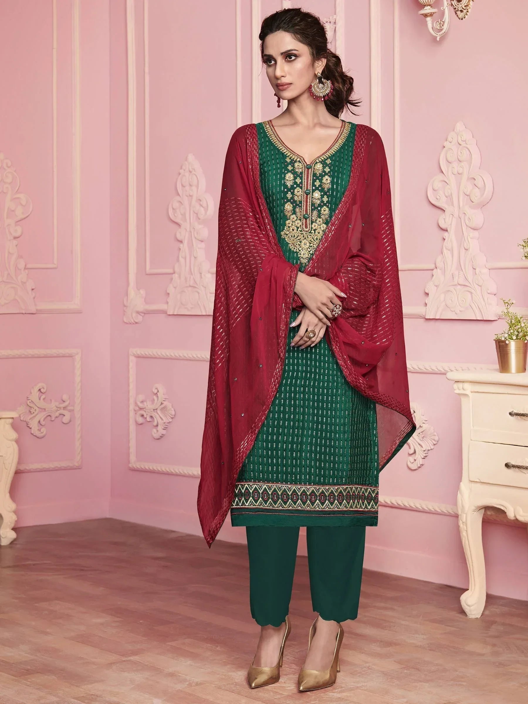 Woman in green embroidered salwar kameez with red dupatta, traditional Indian ethnic wear