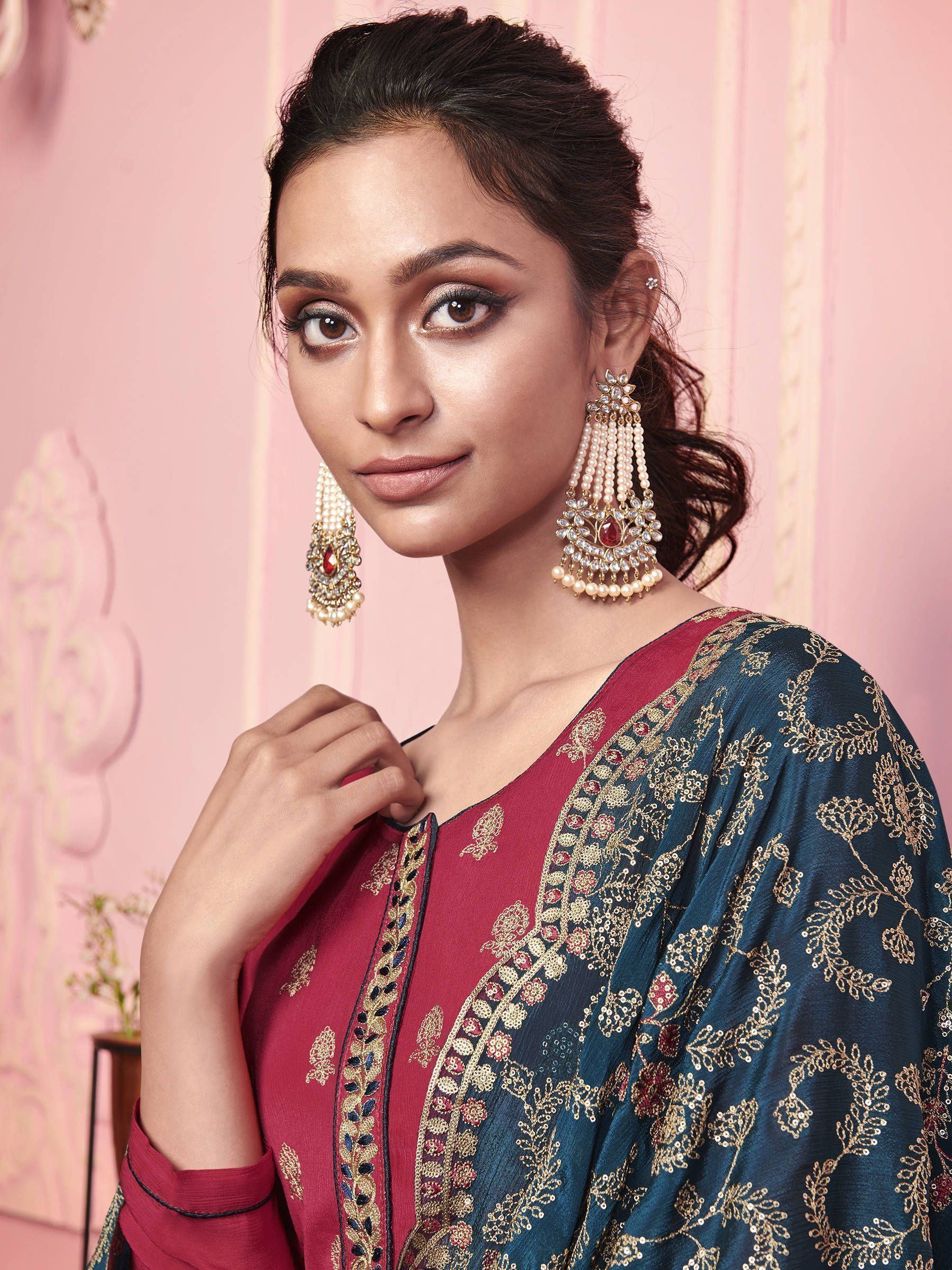 Woman in maroon and blue embroidered ethnic gown with statement pearl earrings
