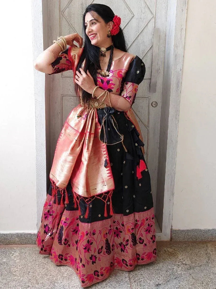 Woman in black and pink floral ethnic gown with gold embroidery, perfect for Indian festive occasions.