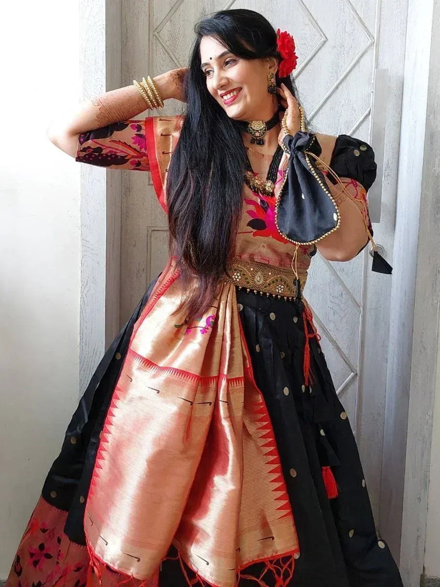 Woman in ethnic Indian lehenga choli with floral print, gold embroidery, and red accents, styled with henna and floral hair accessory