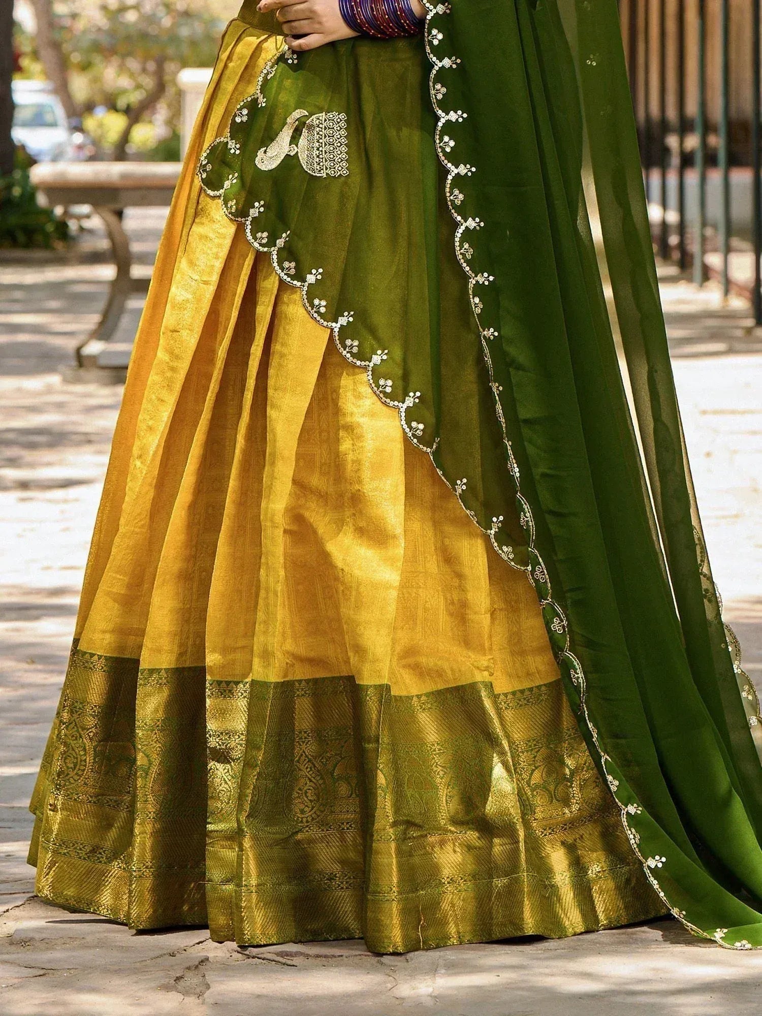 Green and gold embroidered lehenga choli with peacock motif, perfect for Indian ethnic occasions