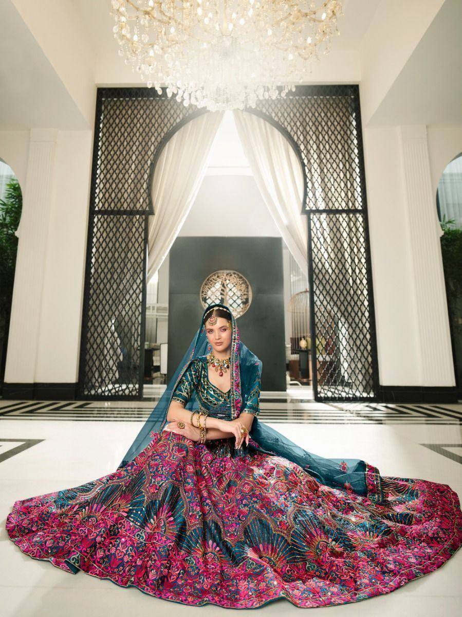 Elegant Indian bridal lehenga choli with vibrant pink and teal embroidery, perfect for weddings and festive occasions.
