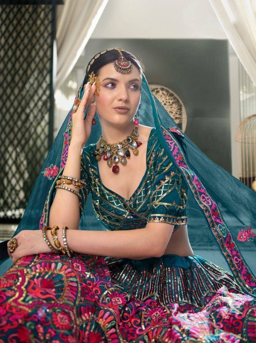 Teal and pink embroidered lehenga choli with gold jewelry and dupatta, Indian ethnic wear