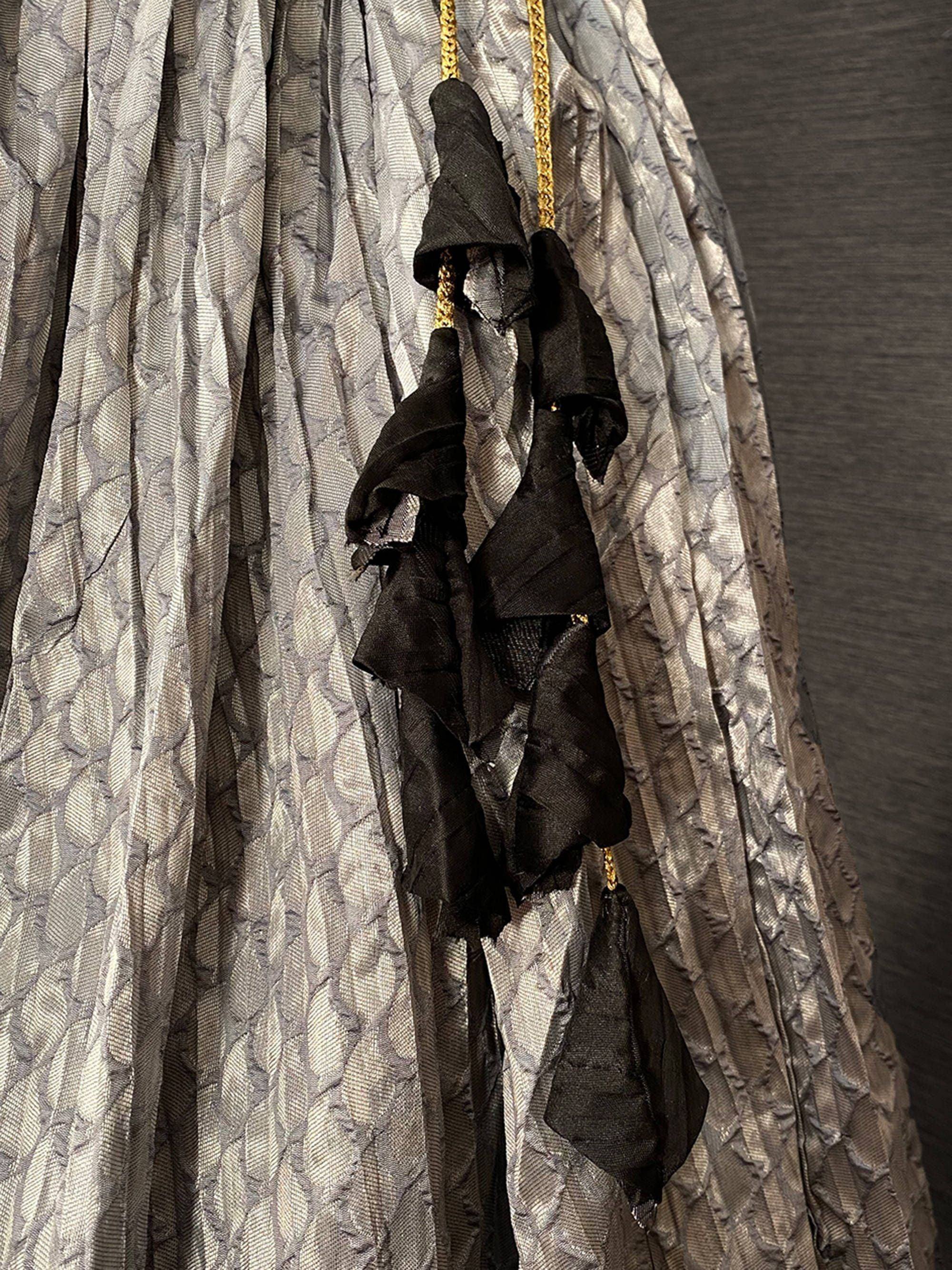 Grey textured ethnic gown with black ruffle tassels and gold chain detailing