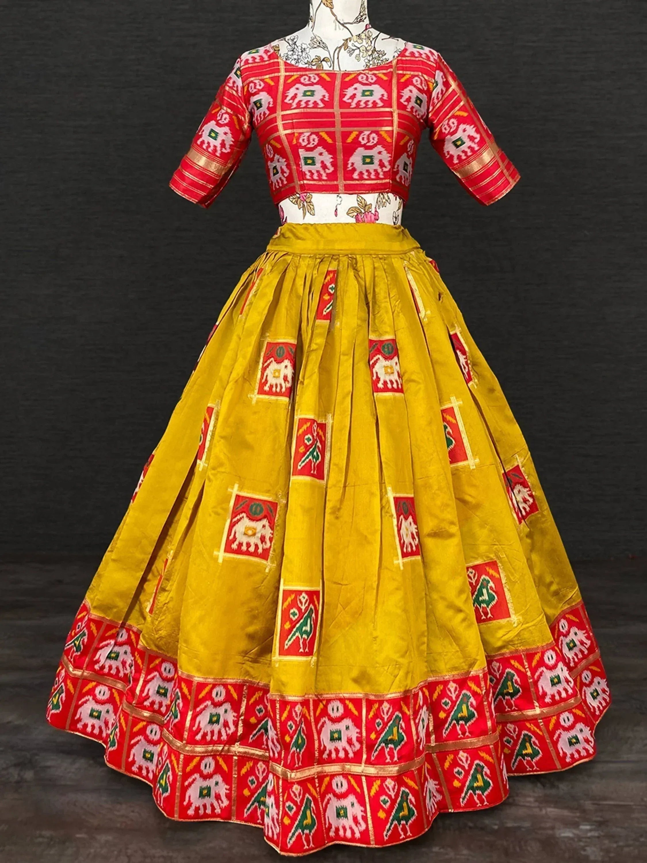 Red and yellow ethnic lehenga choli with elephant print, perfect for Indian weddings and festivals
