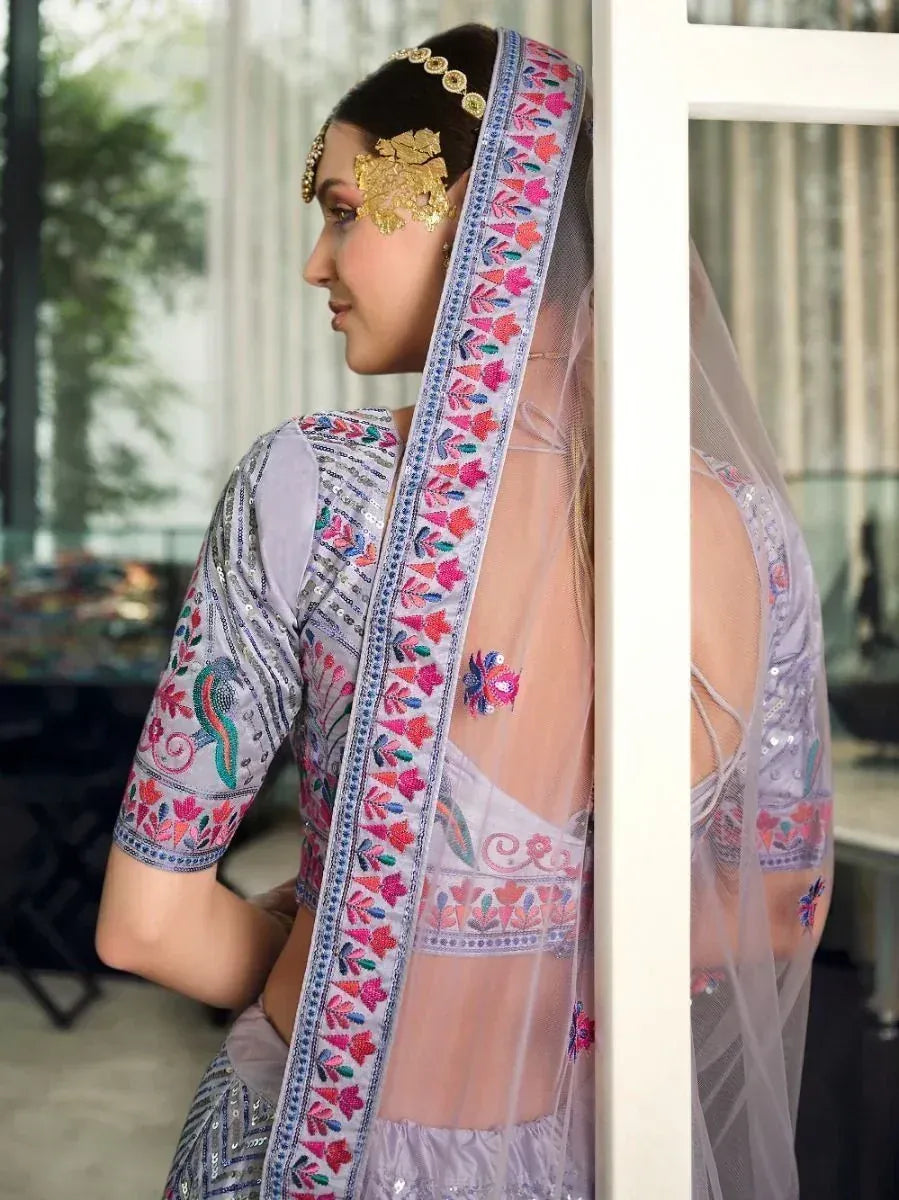 Elegant lavender lehenga choli with floral embroidery, sheer dupatta, and gold bridal jewelry
