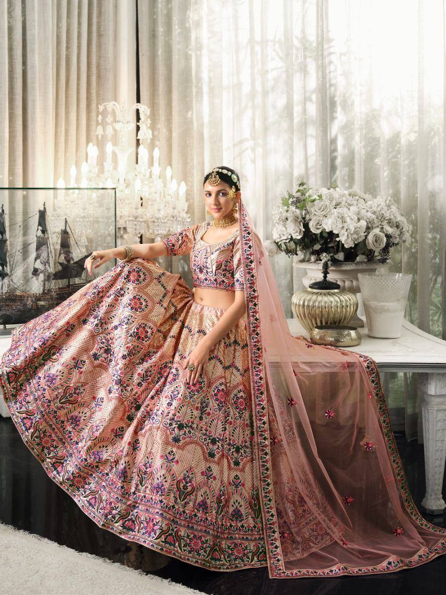 Elegant pink embroidered lehenga choli with floral motifs, perfect for Indian weddings and festive occasions.