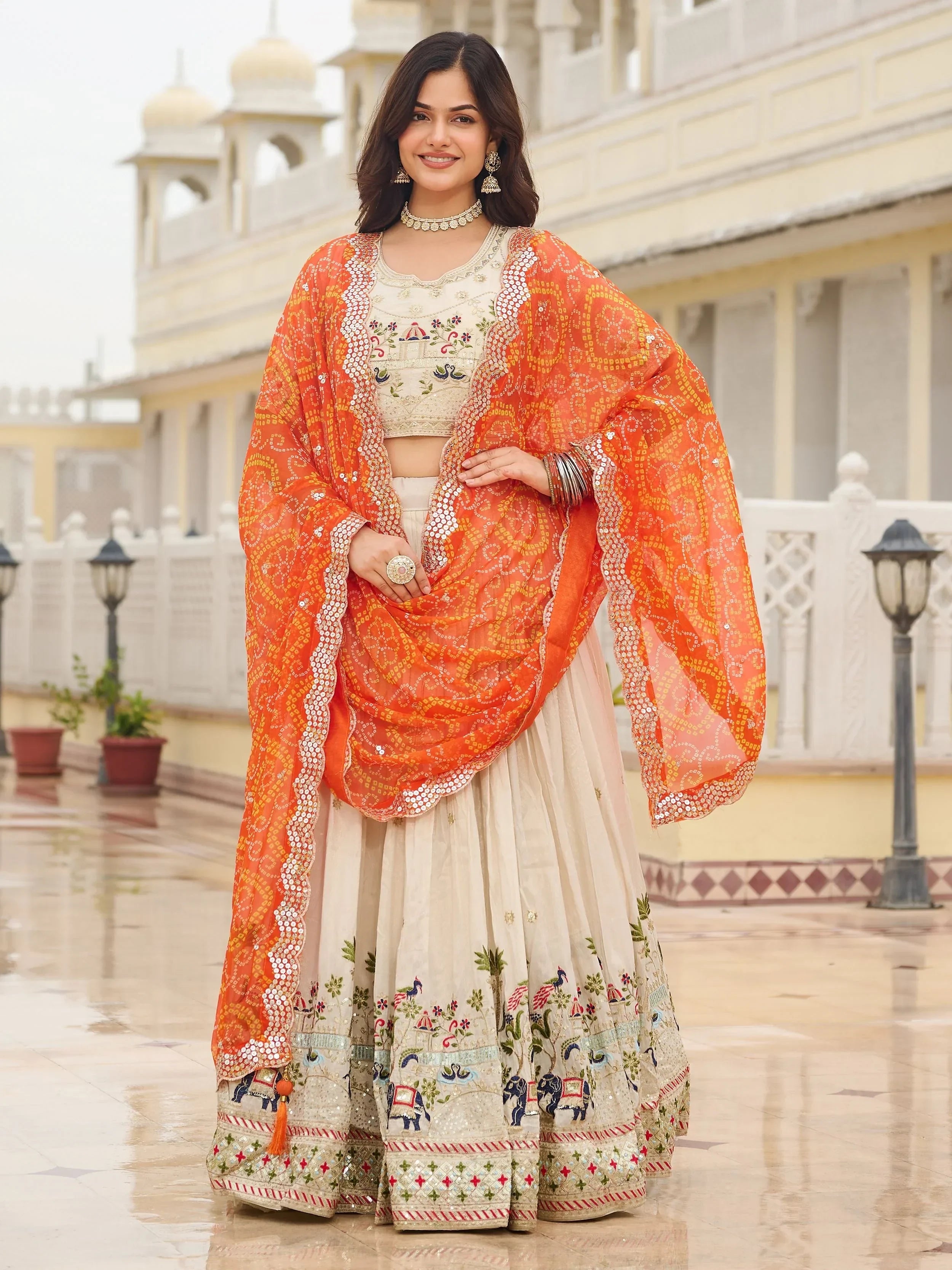 Majestic Off-White Sequnis Silk Lehenga Choli With Orange Dupatta 