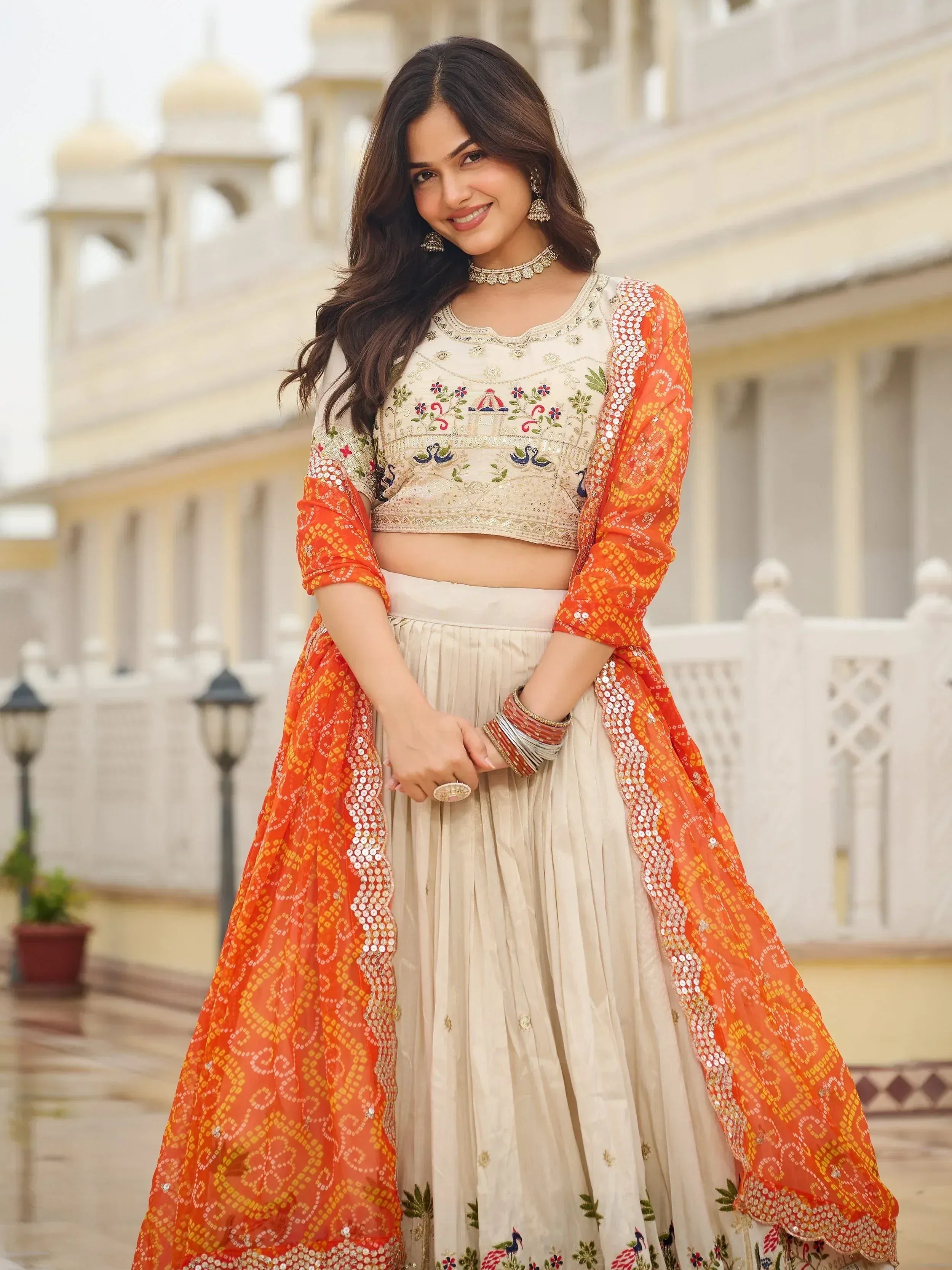 Majestic Off-White Sequnis Silk Lehenga Choli With Orange Dupatta 