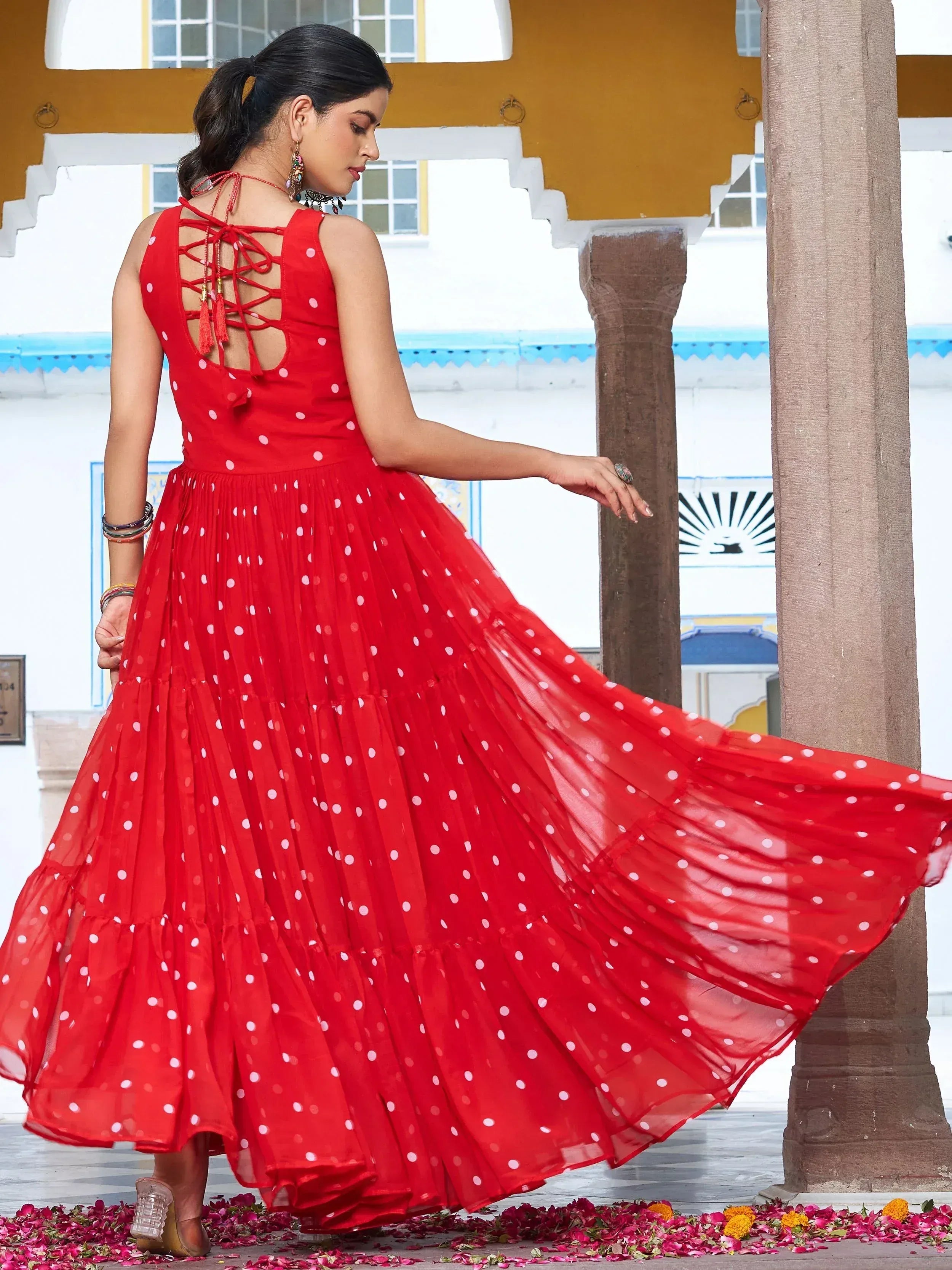Red polka dot ethnic gown with lace-up back, flowing skirt, perfect for festive occasions