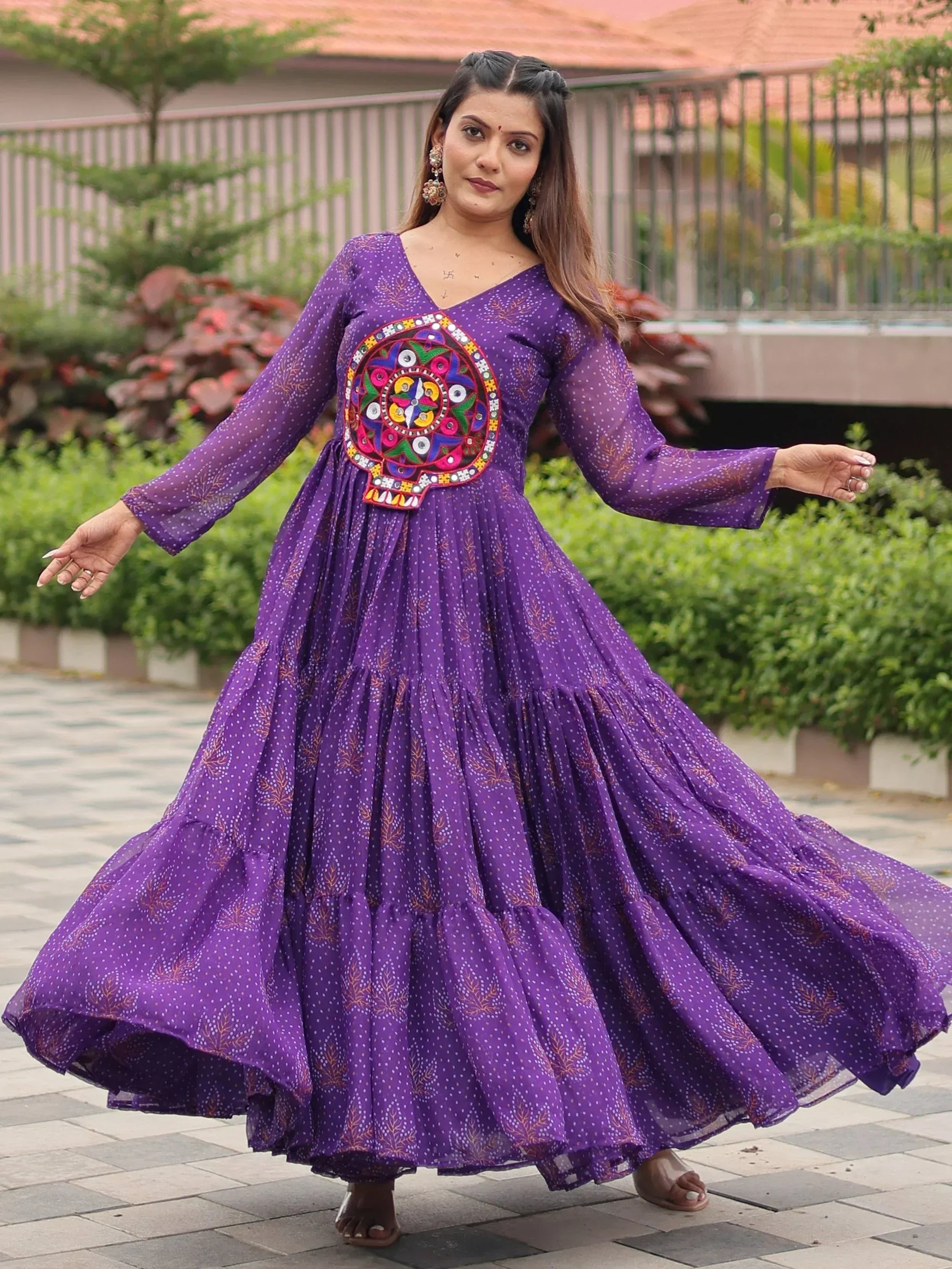 Purple ethnic gown with mirror work, tiered skirt, and long sleeves for women