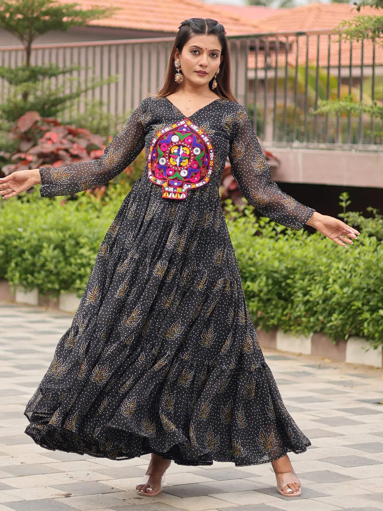 Black ethnic gown with colorful mirror work and gold print, perfect for festive occasions.