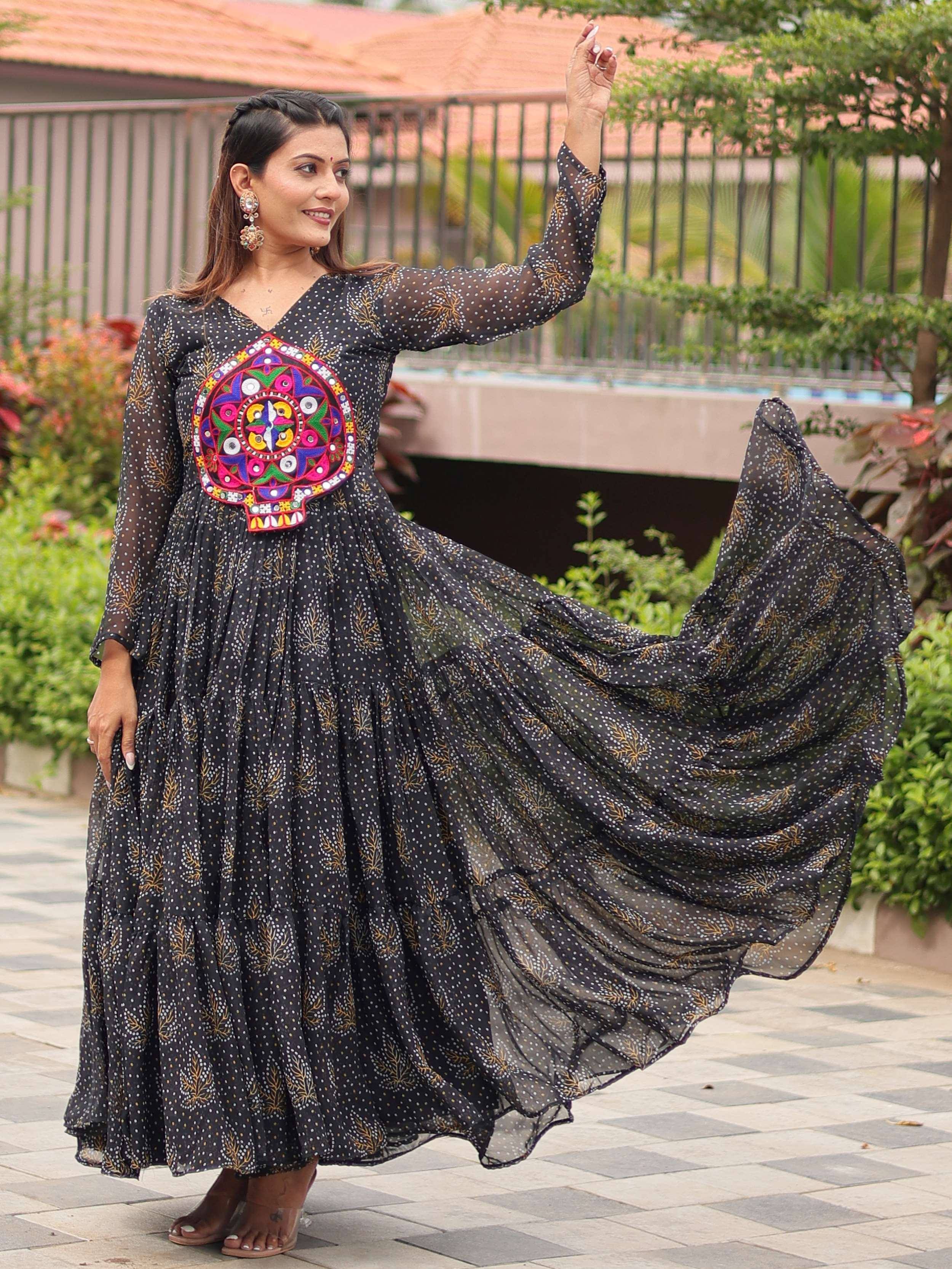 Black ethnic gown with colorful mirror work and polka dot print, perfect for festive occasions