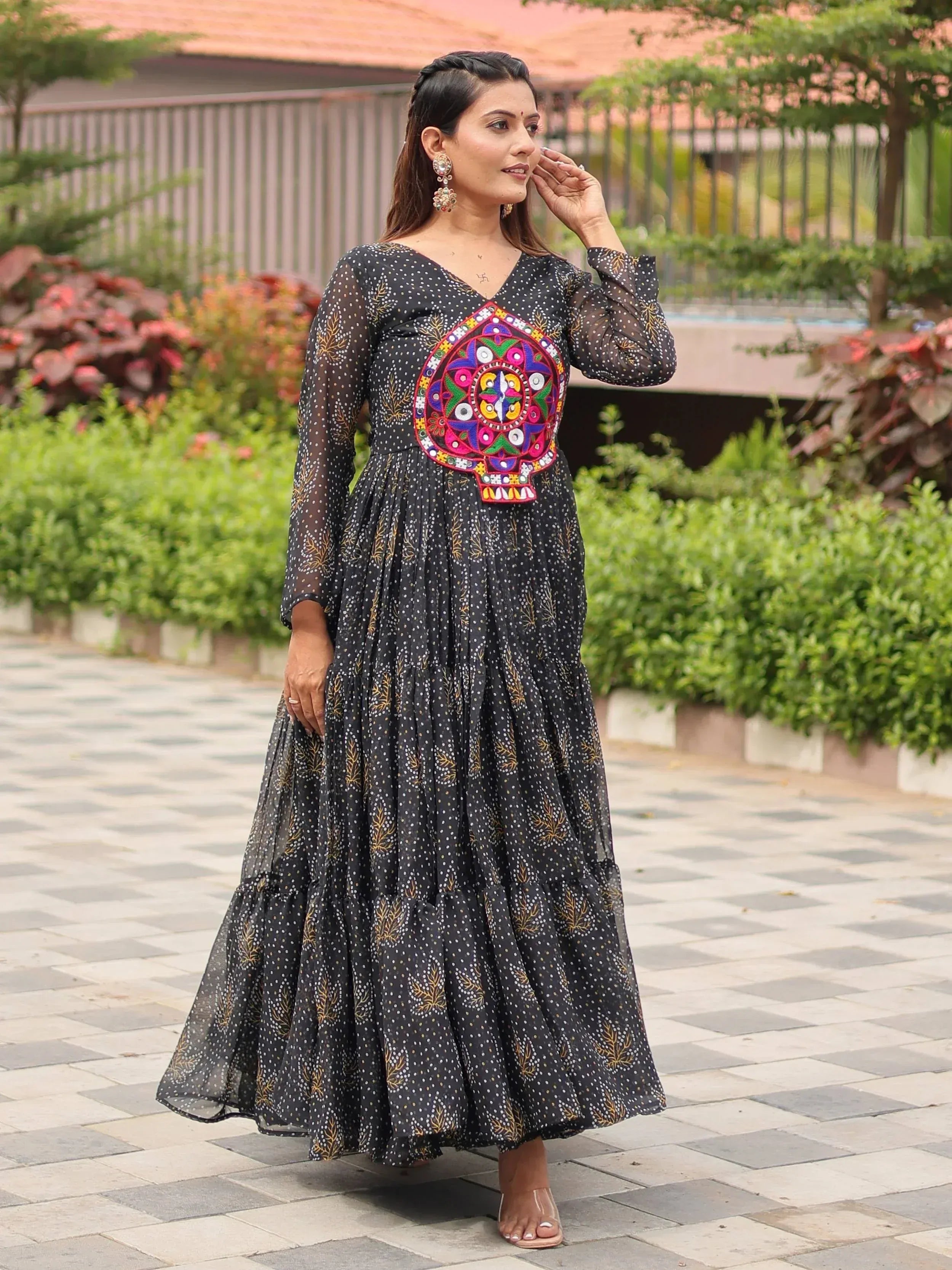 Black ethnic gown with colorful mirror work and polka dot print, perfect for Indian occasions