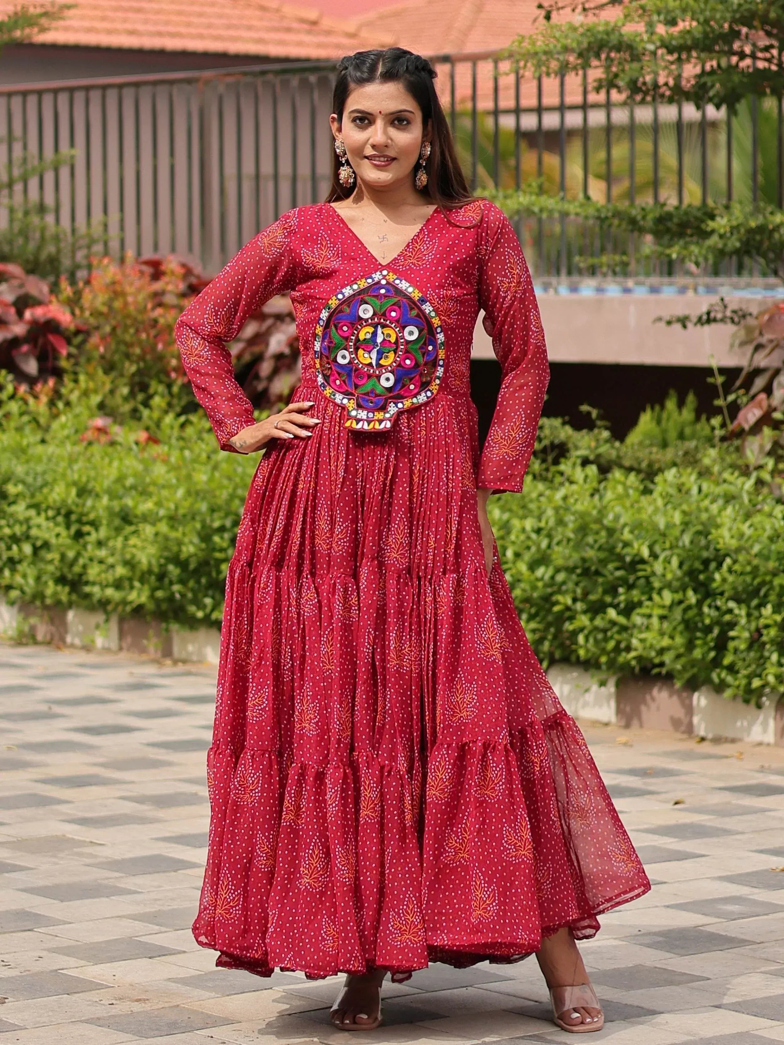 Red ethnic gown with mirror work and printed patterns, perfect for Indian occasions