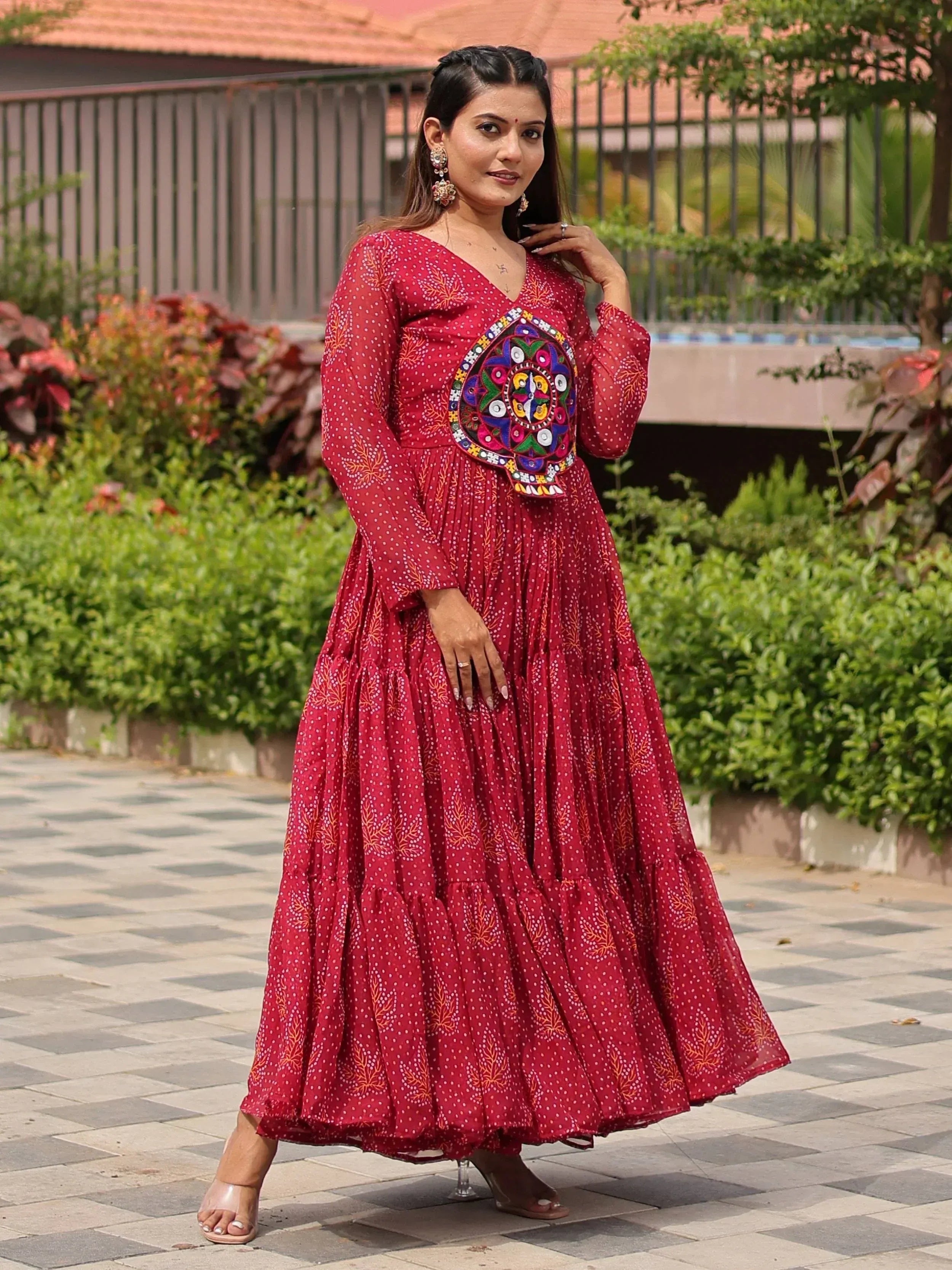 Red ethnic gown with mirror work and polka dots, perfect for Indian occasions