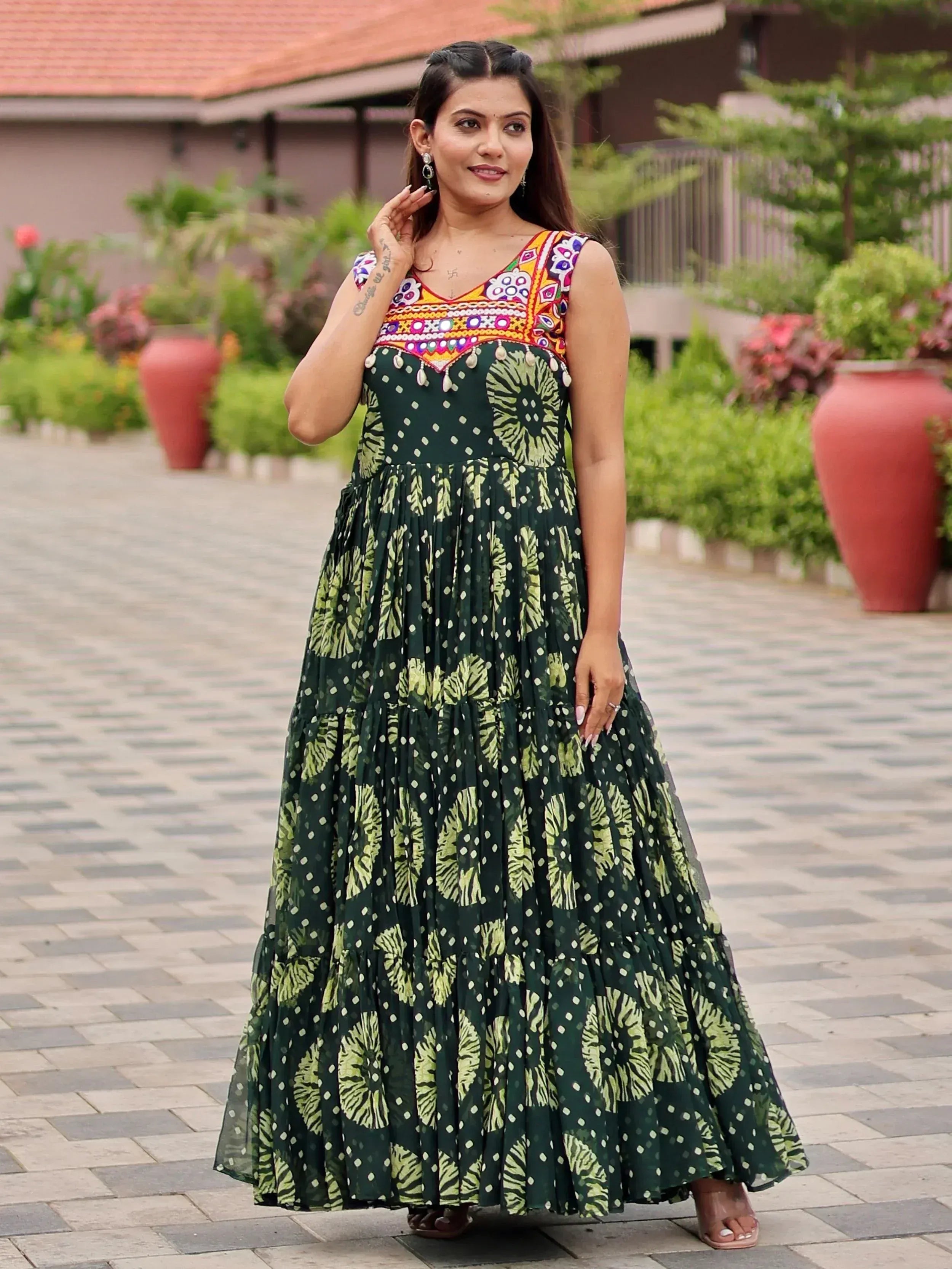 Green printed ethnic gown with colorful embroidered neckline, perfect for Indian festive wear