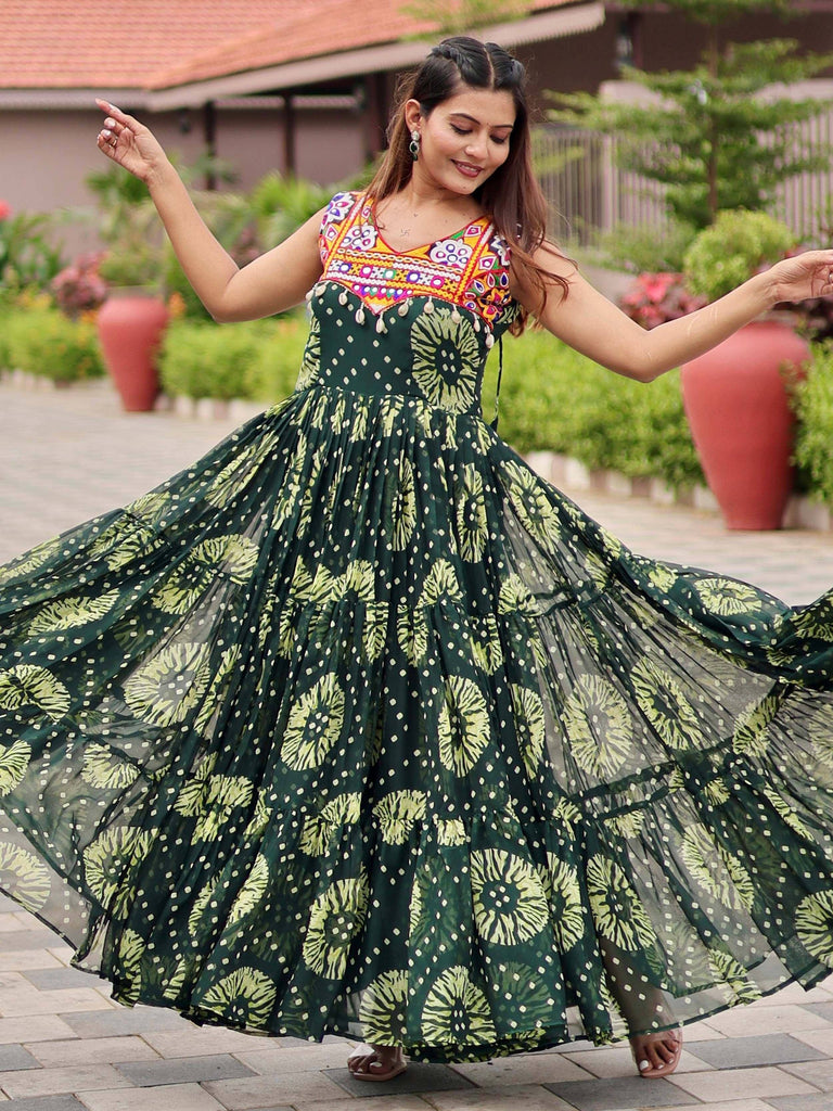 Woman twirling in green floral ethnic gown with embroidered neckline, perfect for Indian festive wear