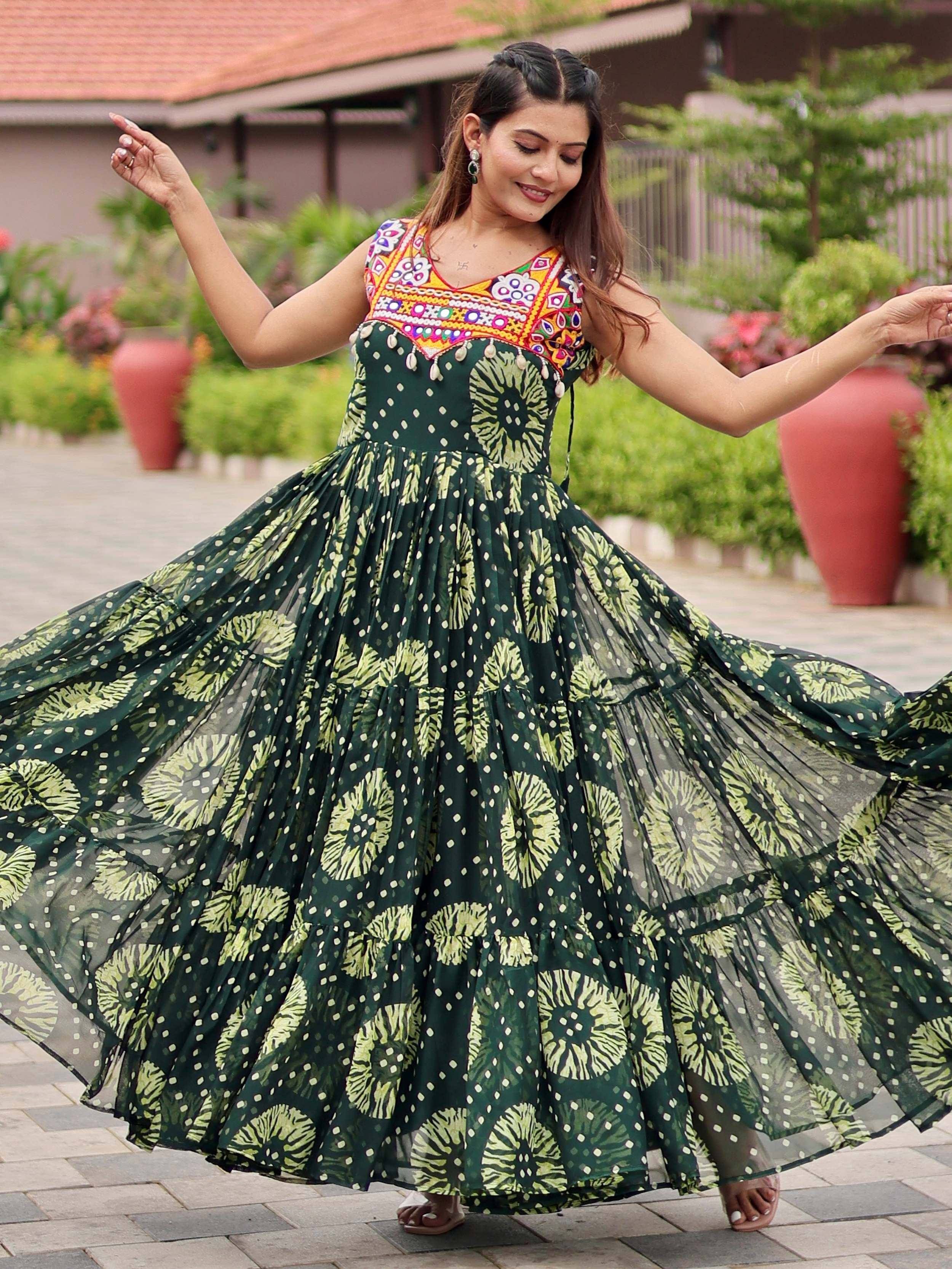 Woman twirling in green floral ethnic gown with embroidered neckline, perfect for Indian festive wear