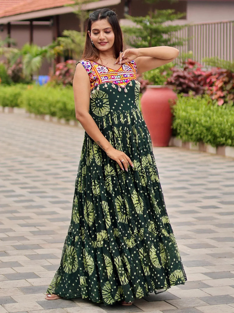 Woman in green floral ethnic gown with colorful embroidered neckline, perfect for Indian occasions.