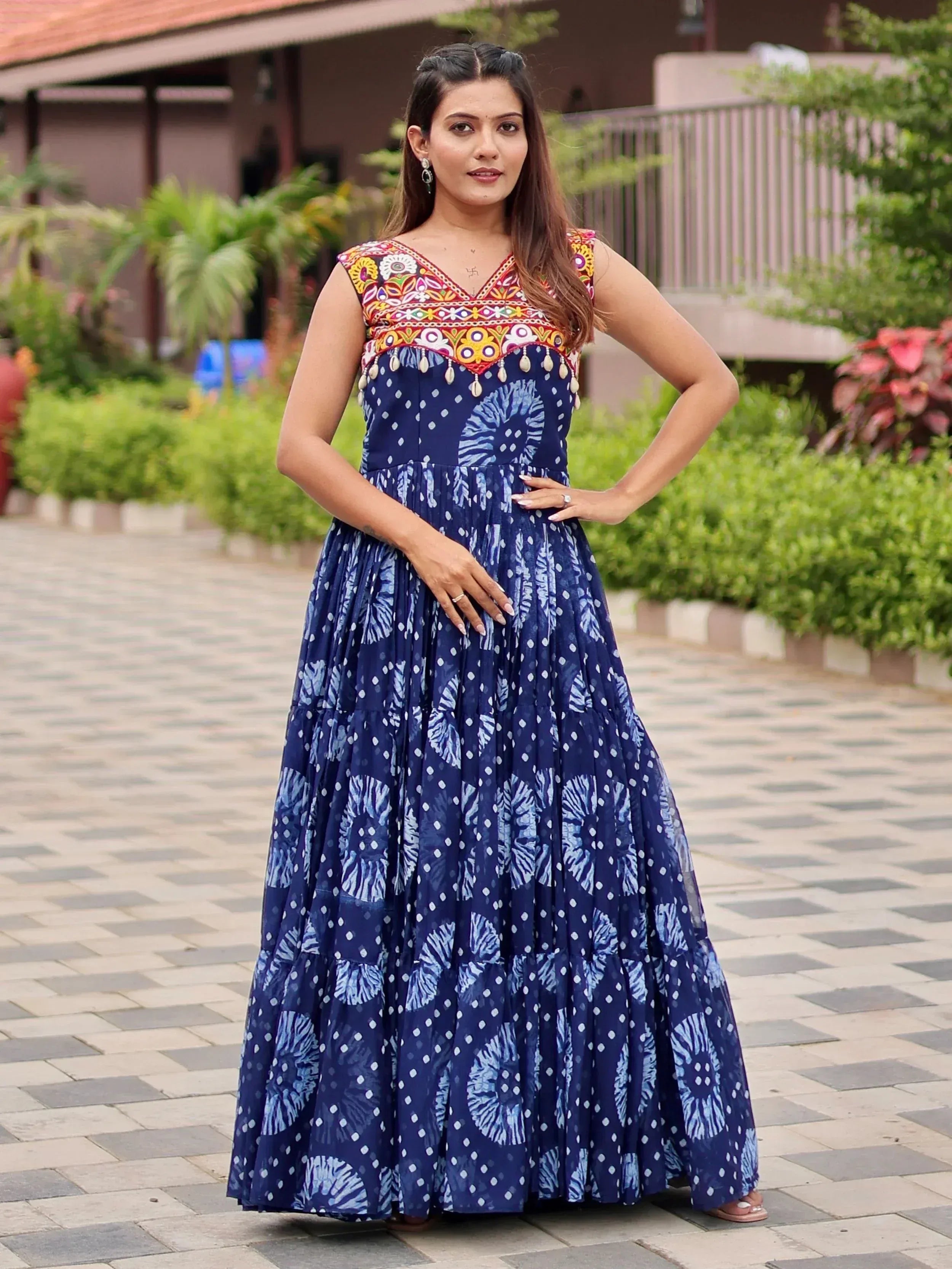 Blue printed ethnic gown with colorful embroidered yoke and tassels, perfect for Indian occasions