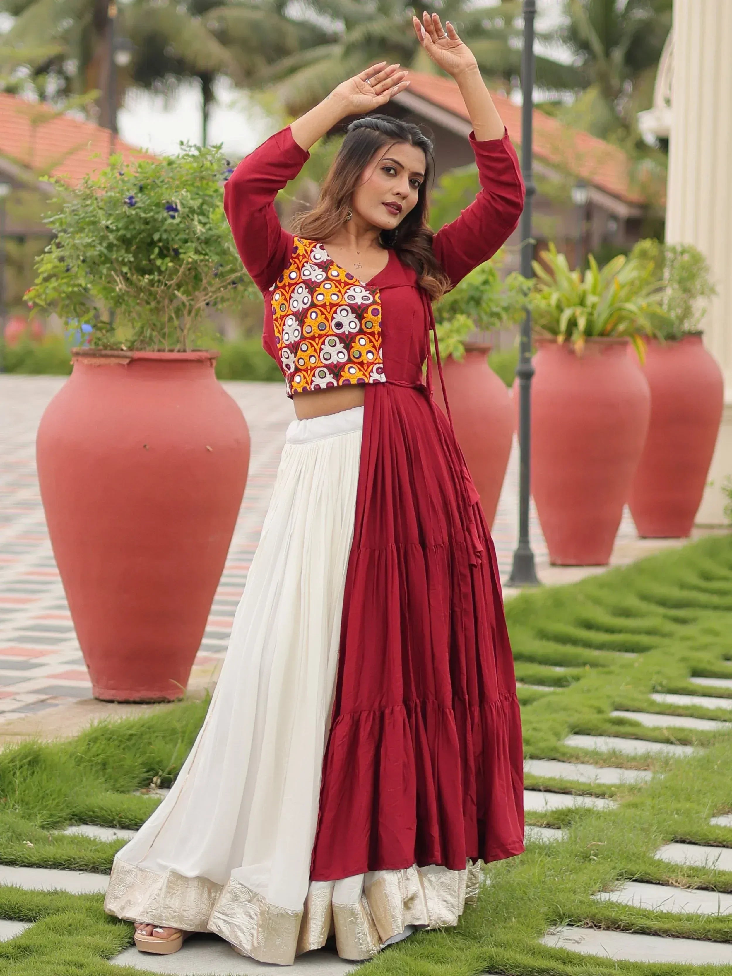 Woman in maroon and white ethnic lehenga with embroidered crop top, perfect for Indian occasions