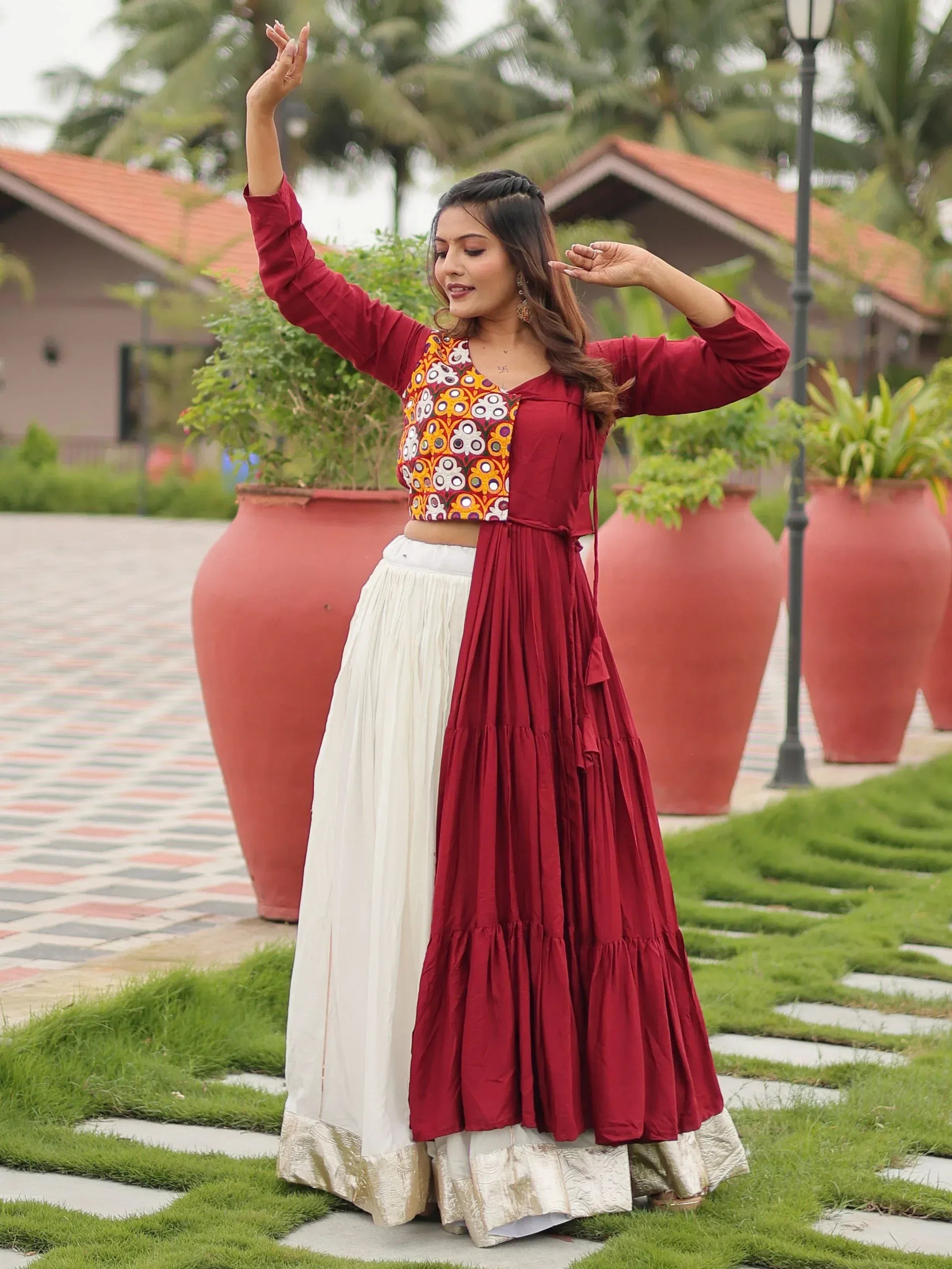 Woman in maroon and white ethnic lehenga choli with embroidered blouse, perfect for Indian festivals and weddings