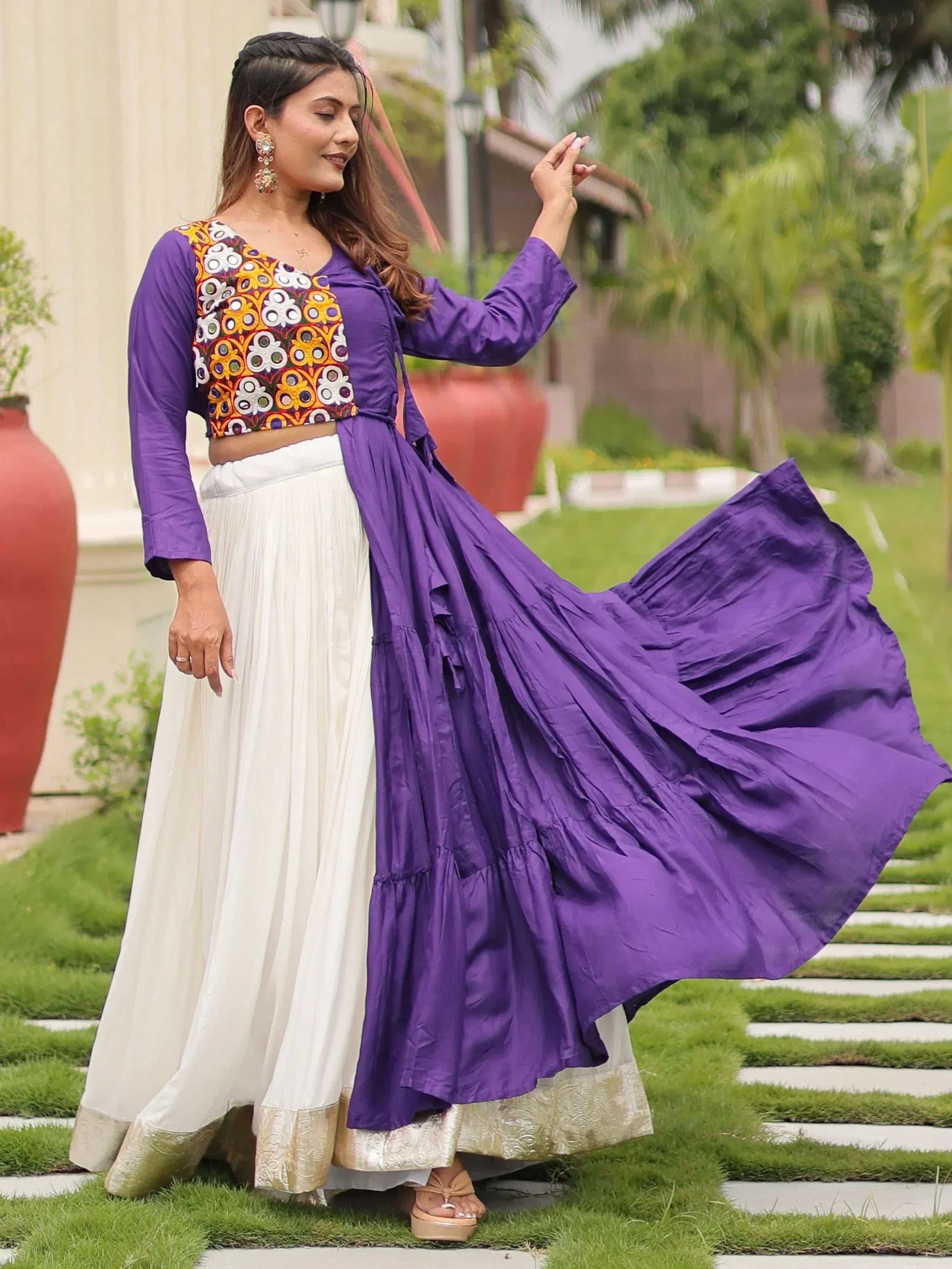 Purple embroidered crop top with white pleated skirt and flowing purple drape, ethnic wear for women