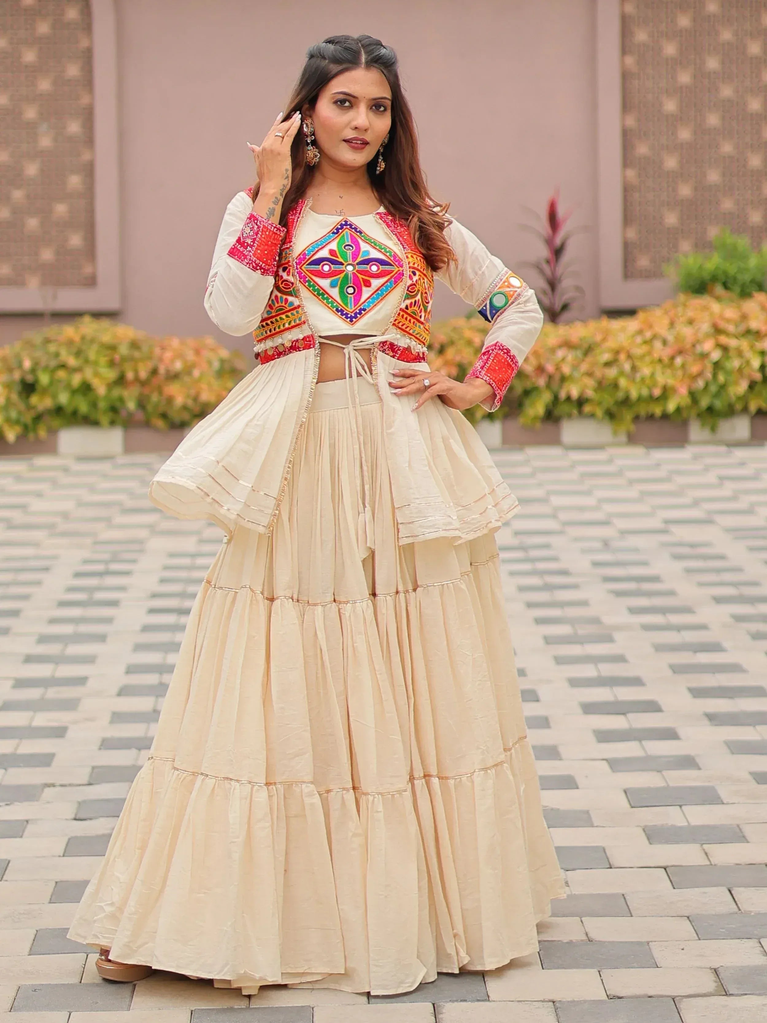 Cream embroidered lehenga choli with colorful mirror work, perfect for Indian ethnic wear and festive occasions.