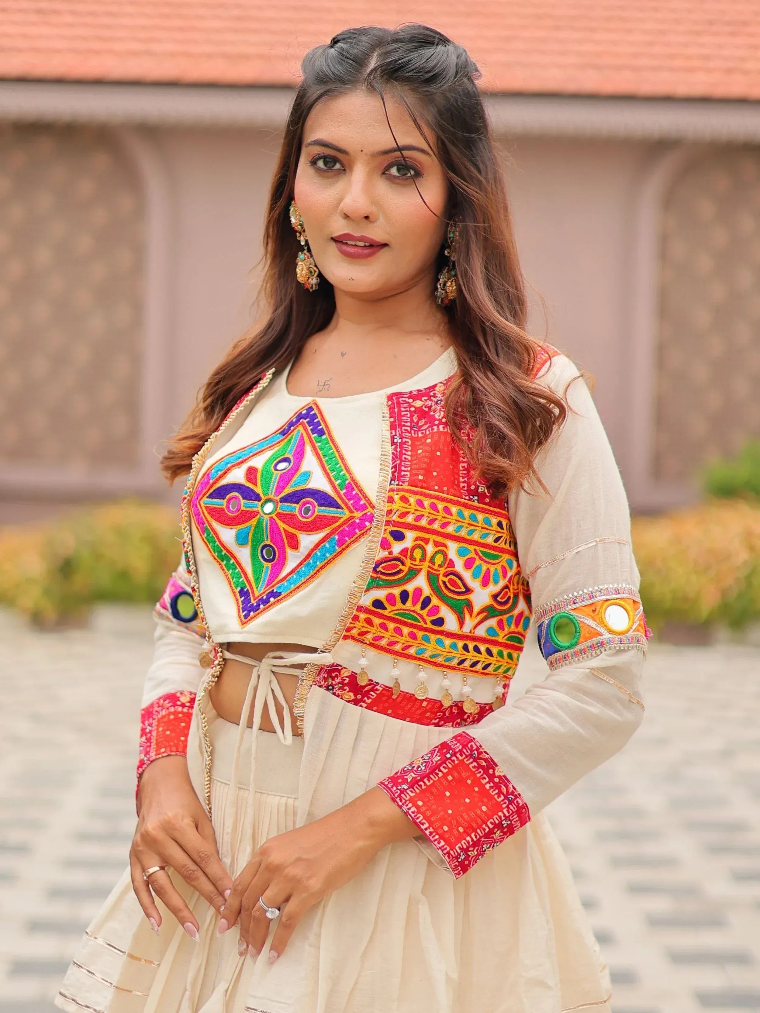 Woman in colorful embroidered Indian ethnic wear with mirror work and mirror embellishments
