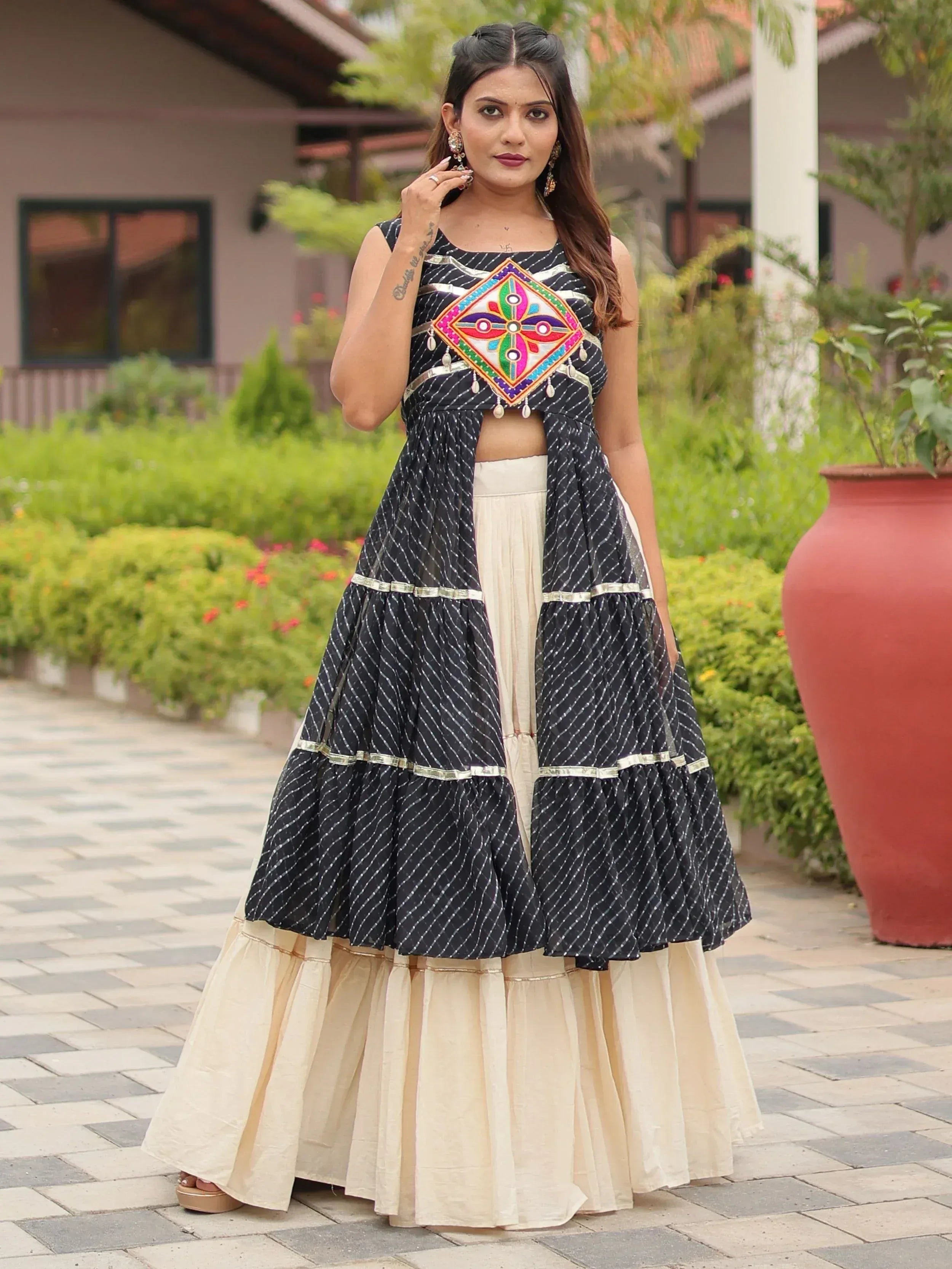 Black and cream ethnic lehenga with colorful embroidery and layered skirt