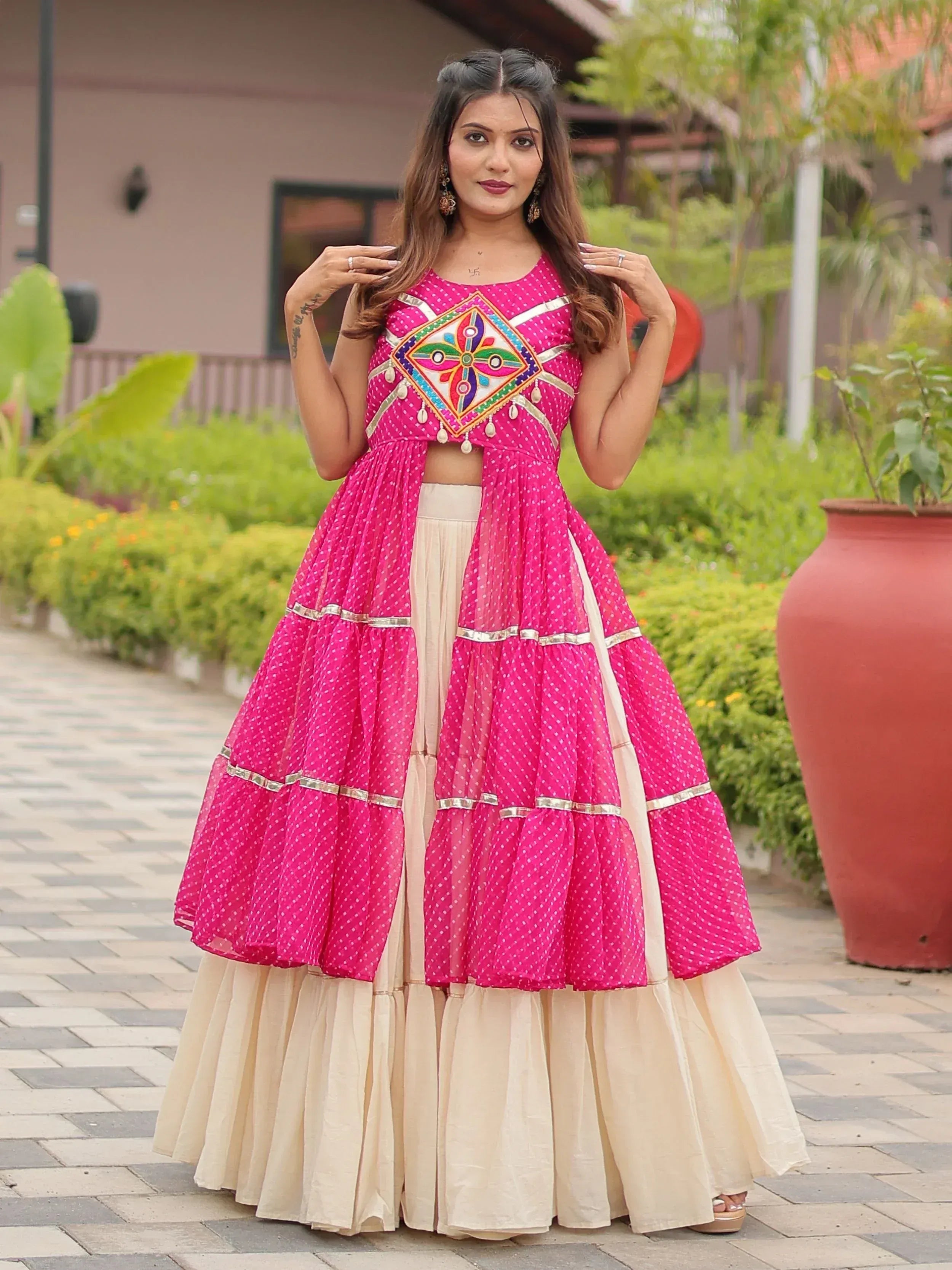 Pink polka dot lehenga choli with embroidered top and tiered skirt, perfect for Indian ethnic wear