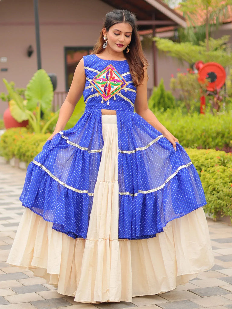 Blue polka dot ethnic lehenga with colorful embroidery and cream skirt, perfect for Indian festive occasions