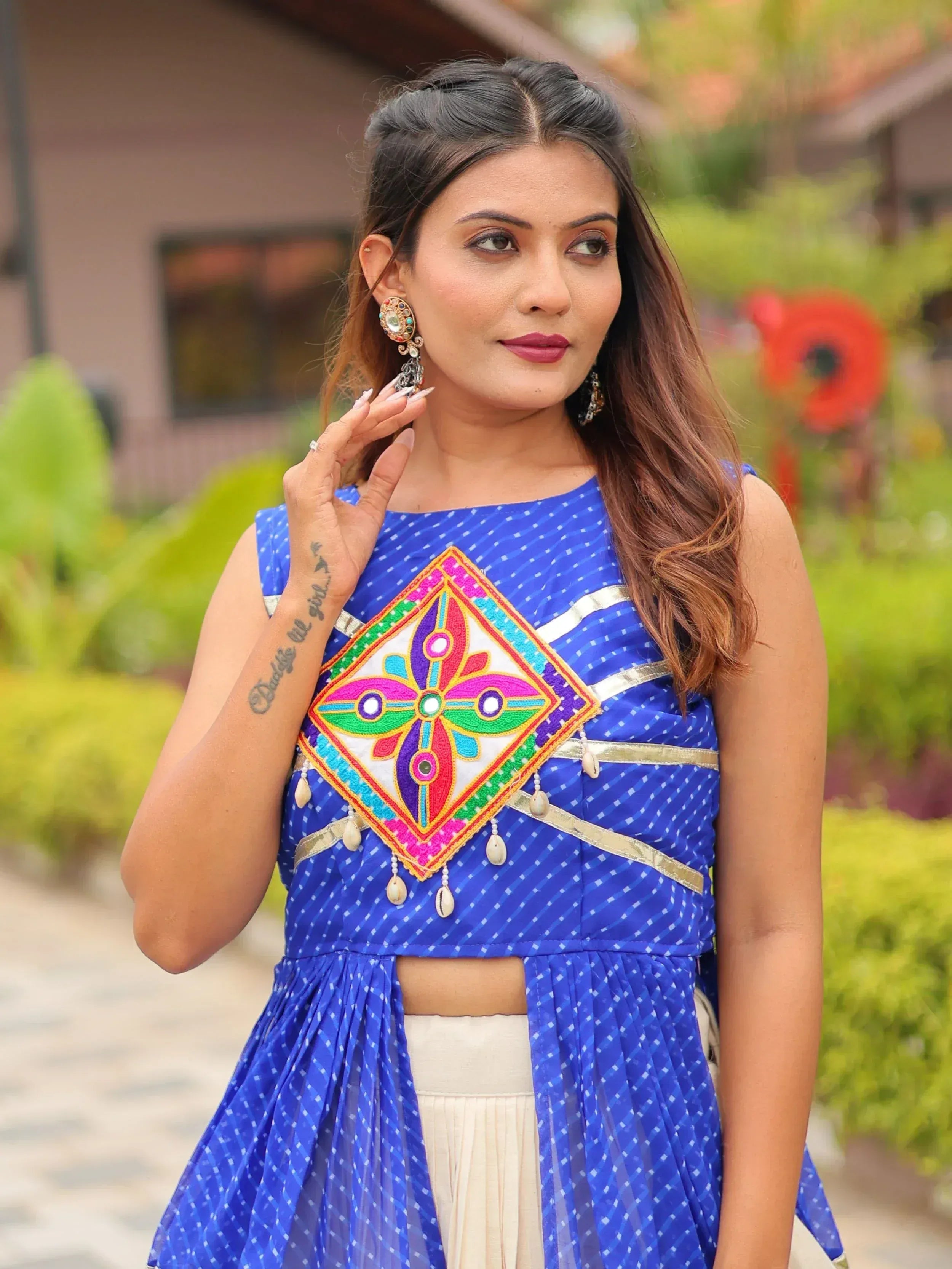 Blue ethnic gown with colorful mirror work and shell embellishments, perfect for Indian festive wear.