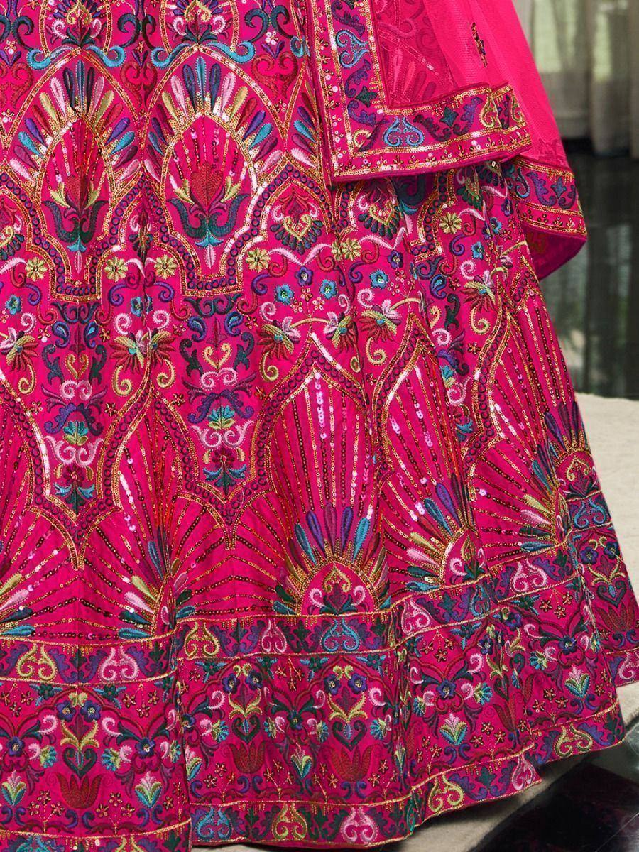 Fuchsia pink lehenga with intricate floral embroidery and sequin detailing, perfect for Indian ethnic wear.