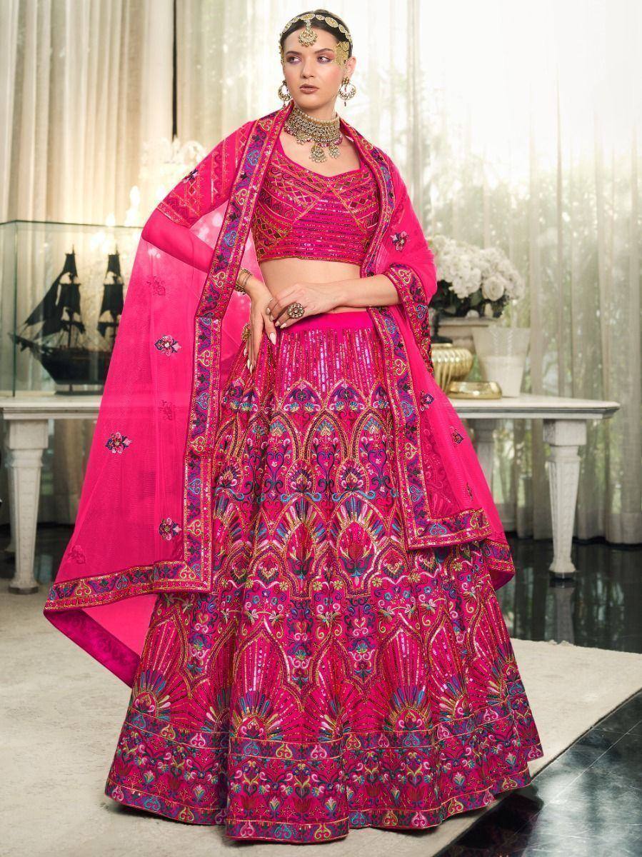 Pink designer lehenga choli with intricate embroidery and matching dupatta, perfect for Indian weddings and festive occasions.
