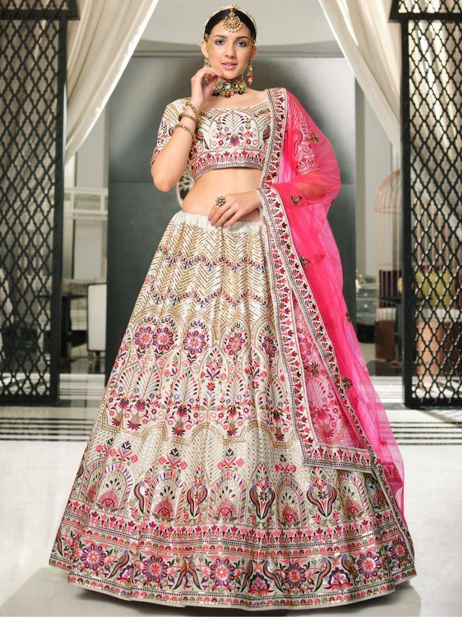 Elegant ivory lehenga choli with pink floral embroidery and matching dupatta, perfect for Indian weddings