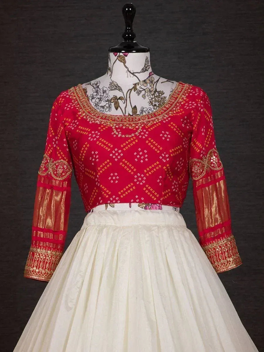 Red embroidered blouse with gold detailing paired with white lehenga skirt, Indian ethnic wear