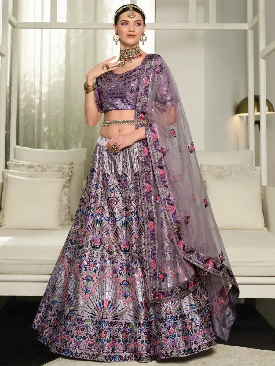 Purple embroidered lehenga choli with floral motifs and sheer dupatta, perfect for Indian weddings and festive occasions.