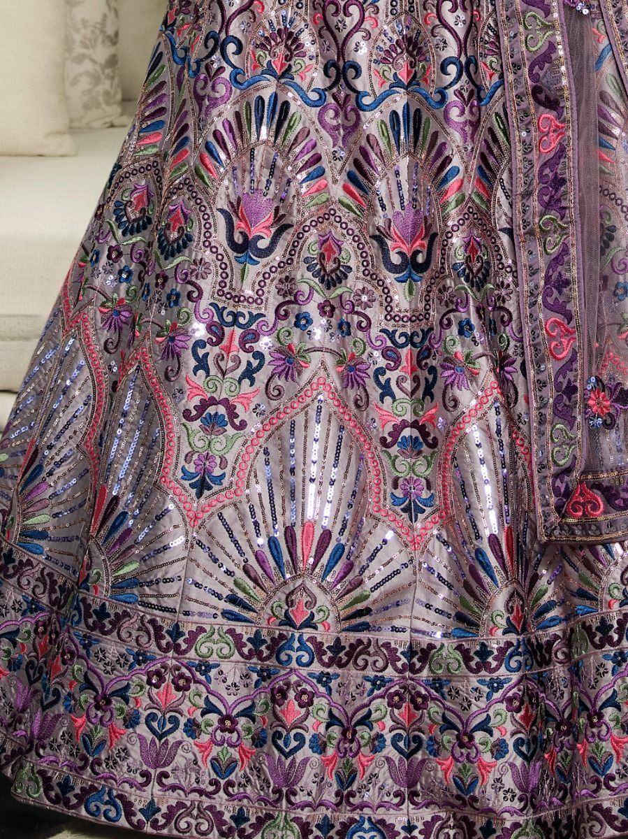 Designer lehenga with intricate floral embroidery and sequin work in purple, pink, and blue tones