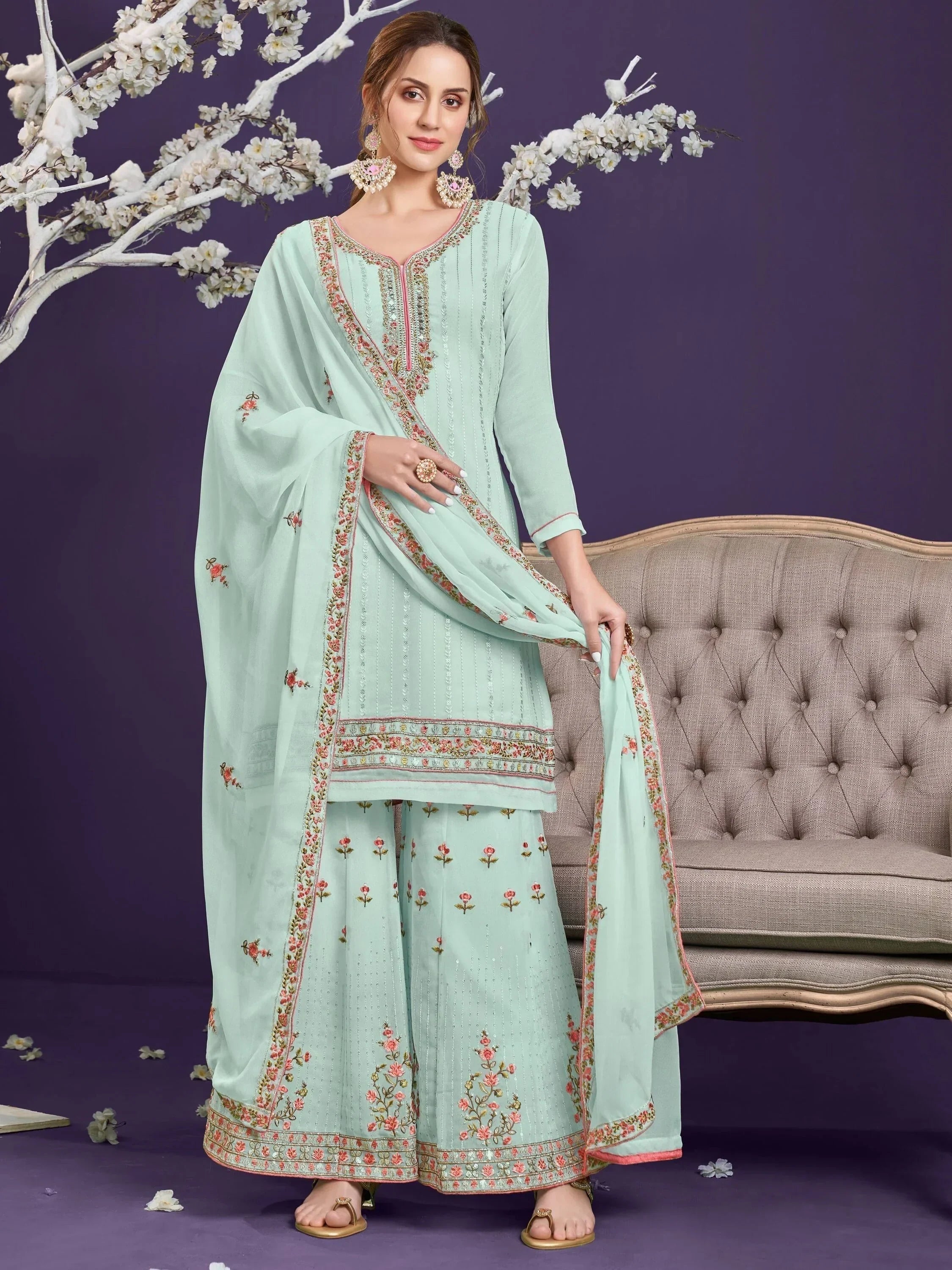 Woman wearing pastel green embroidered salwar kameez with floral dupatta, ethnic wear