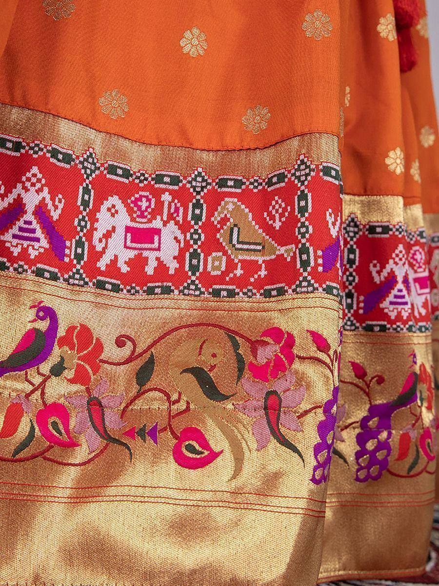Orange ethnic lehenga with embroidered elephants, peacocks, and floral motifs on border