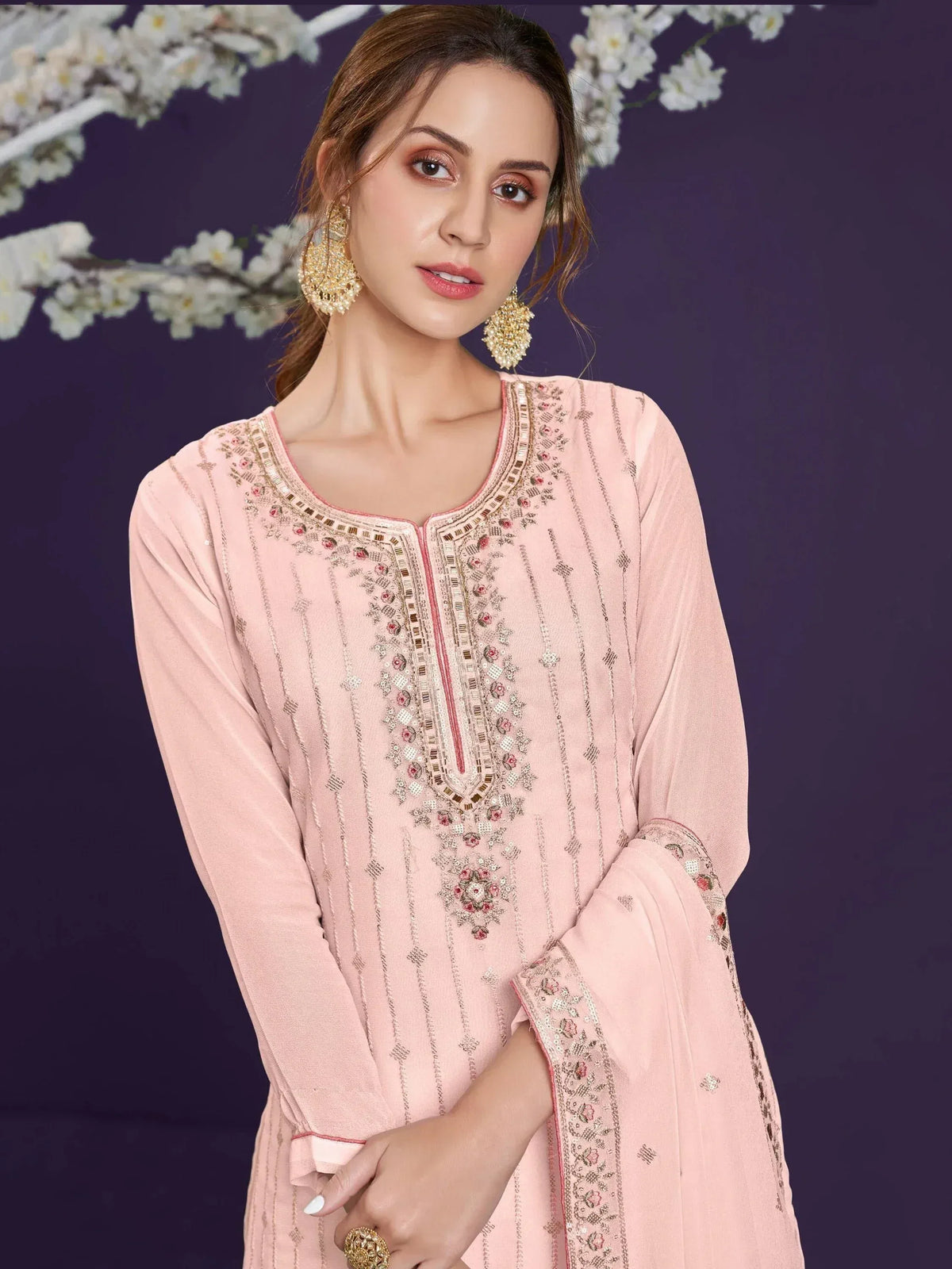 Pink embroidered ethnic kurti with gold detailing, perfect for Indian festive wear and designer occasions.